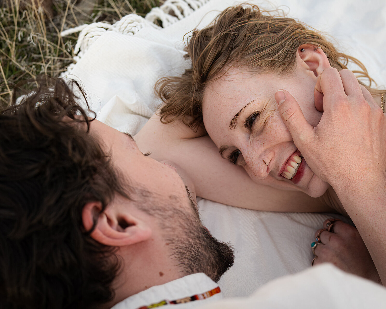 couple on blanket laughing at each other in reno nevada