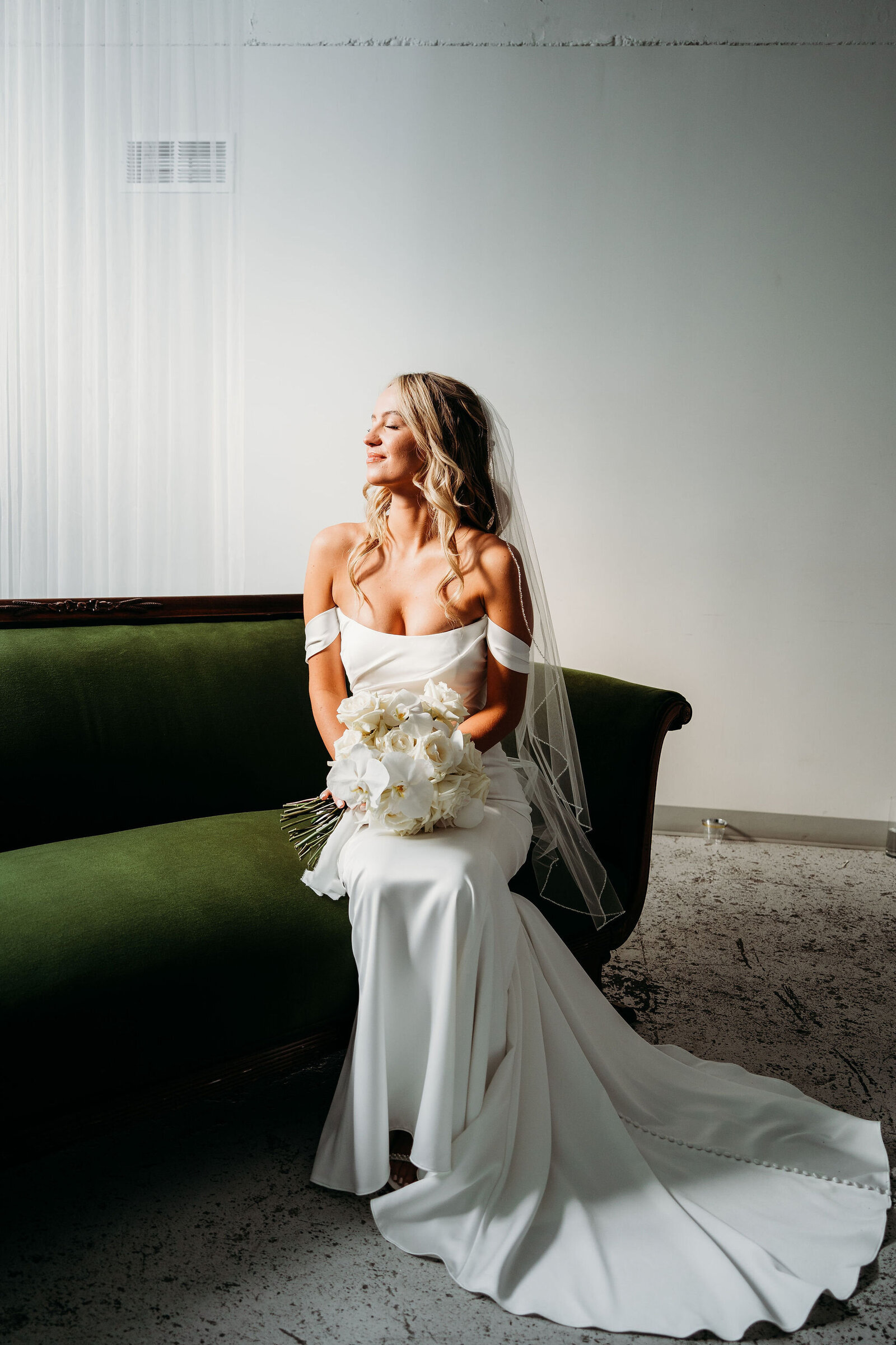 Bridal portraits on a green couch at the St Vrain, Longmont wedding venue