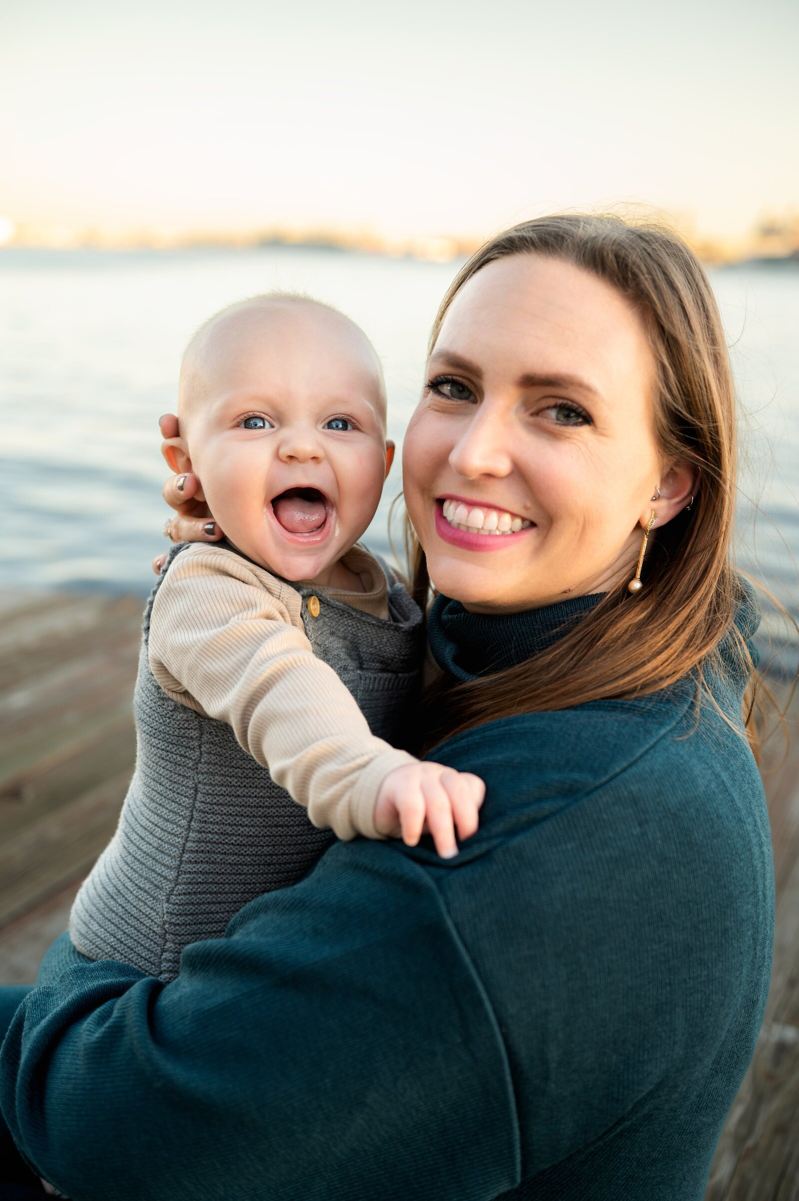 6 month old smiling as mom holds him in Baltimore, Maryland