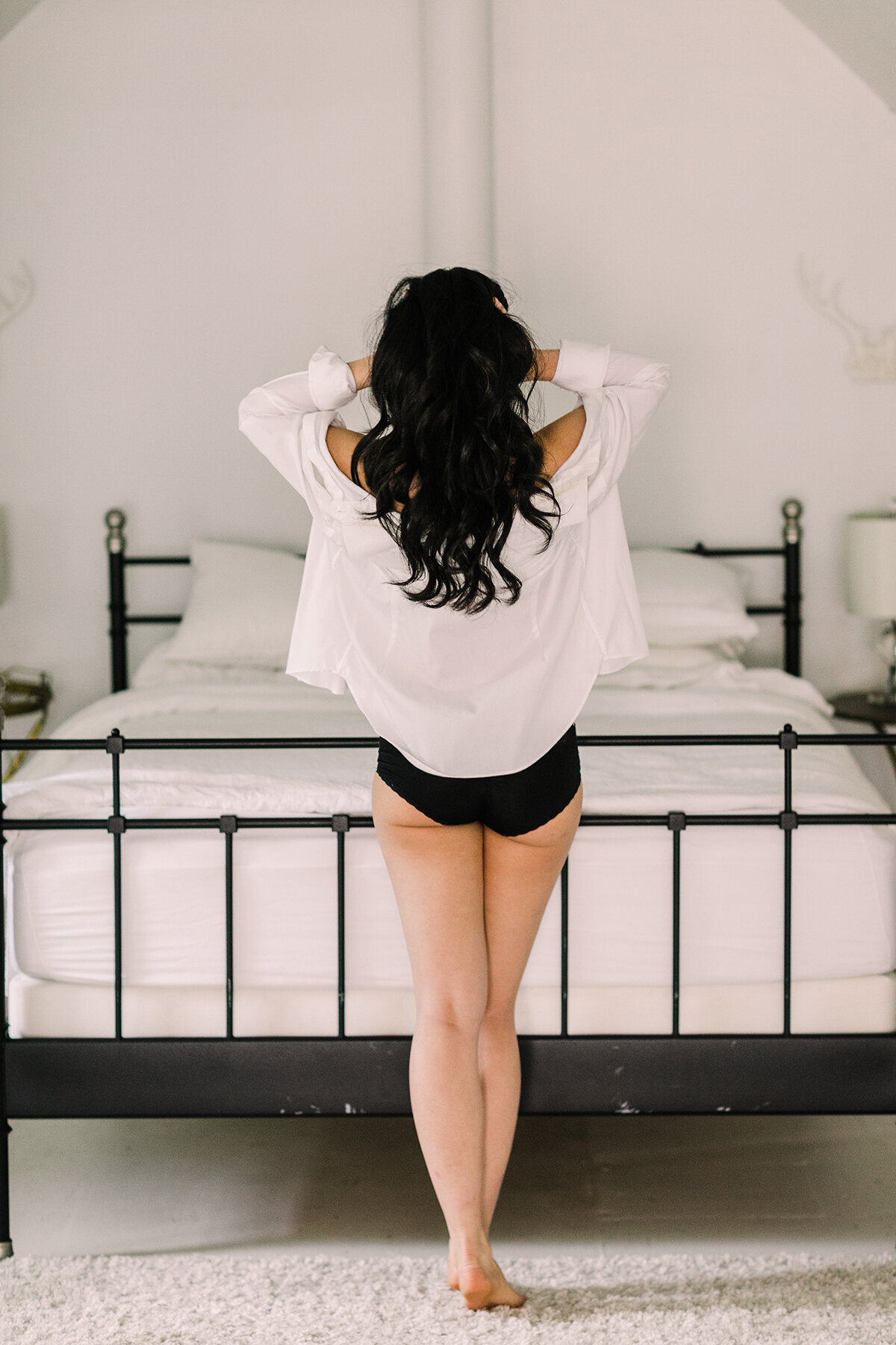 A simple white button down shirt is the perfect wardrobe accessory for a boudoir session.
