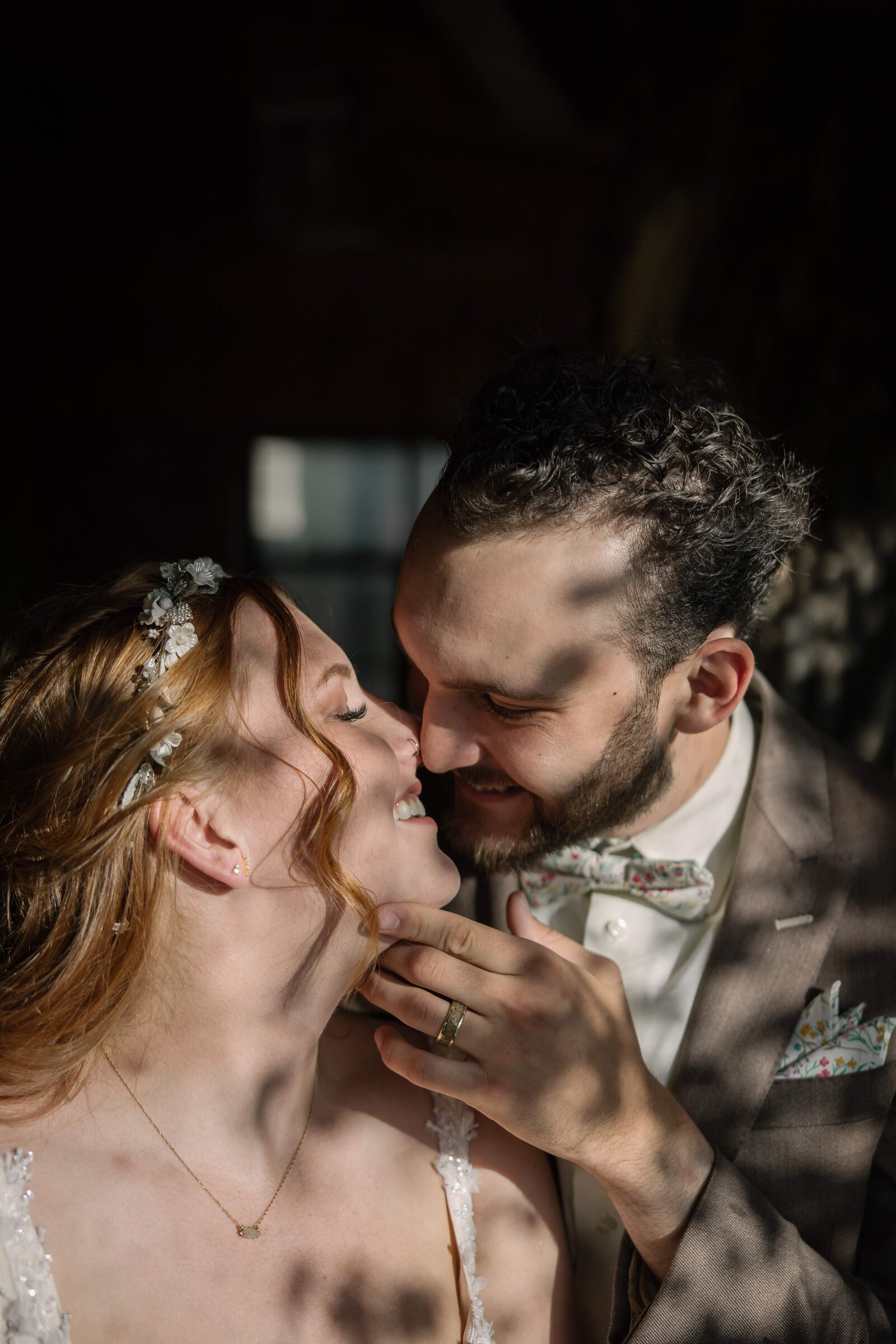 shadow of leaves on bride and groom kissing