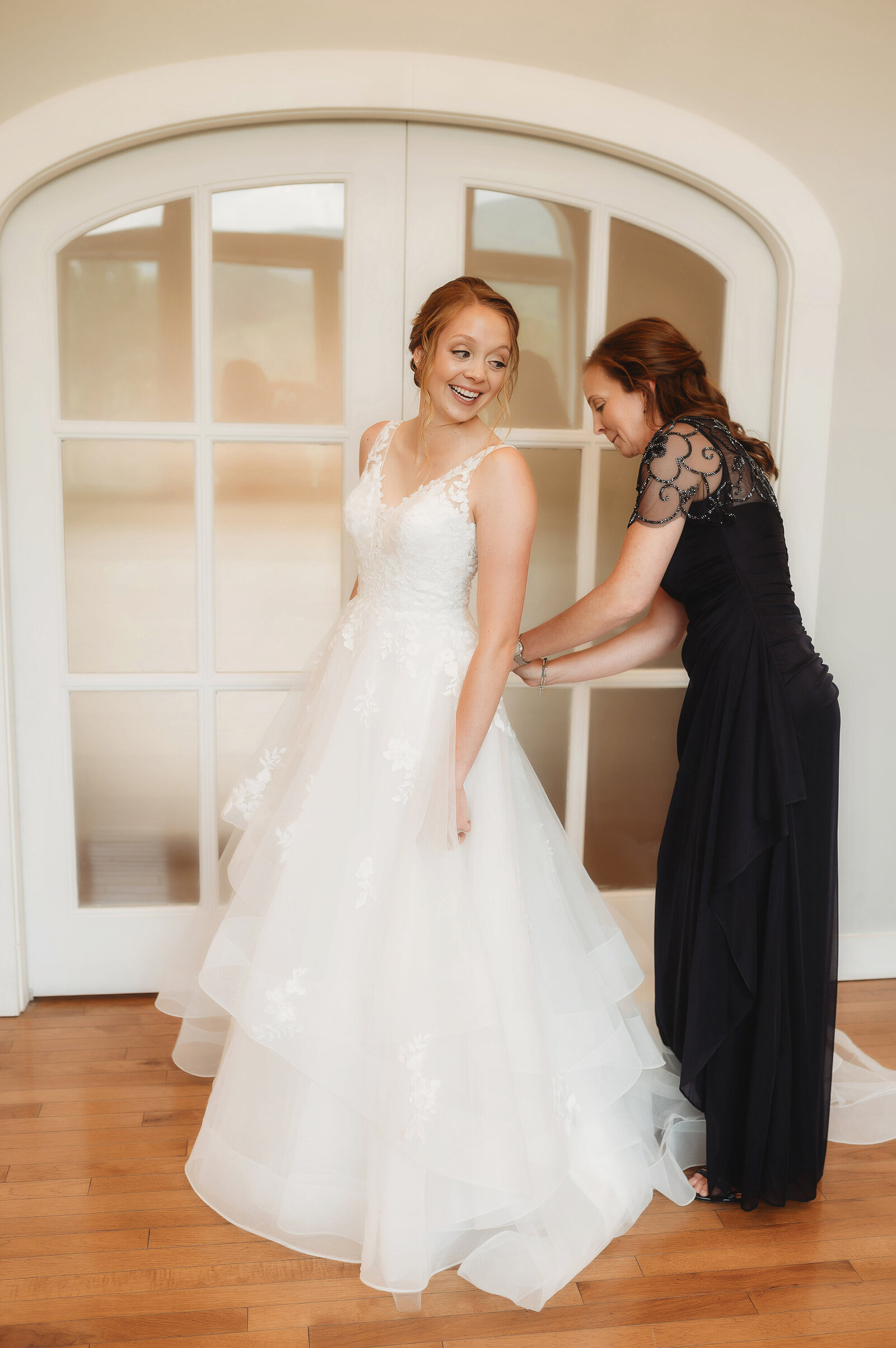 Bride prepares for her wedding day with her mother in the bridal suit at Chestnut Ridge Events in Asheville, NC