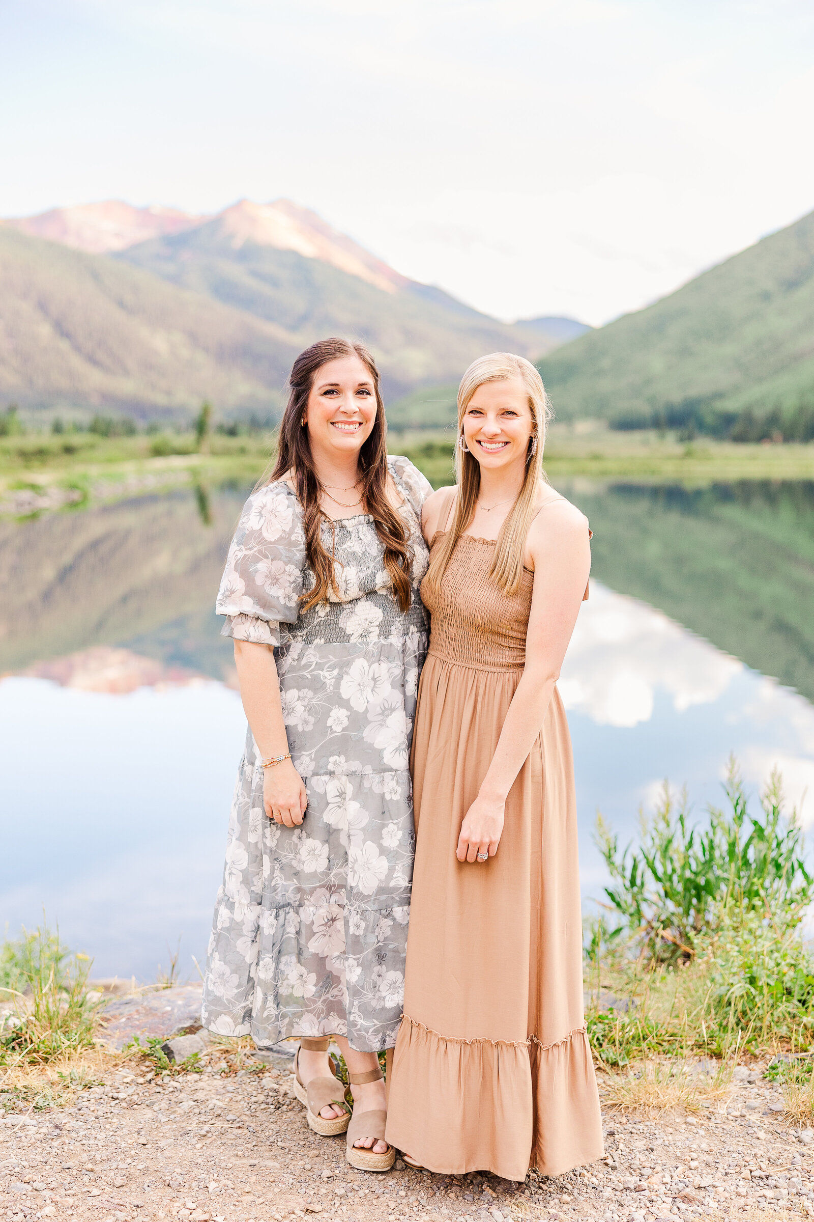 sisters stand in front of crystal lake