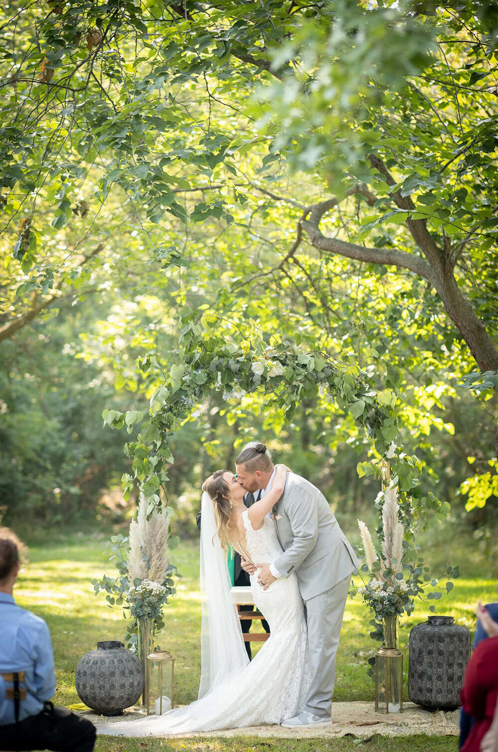 first kiss of bride and groom at the end of wedding ceremony