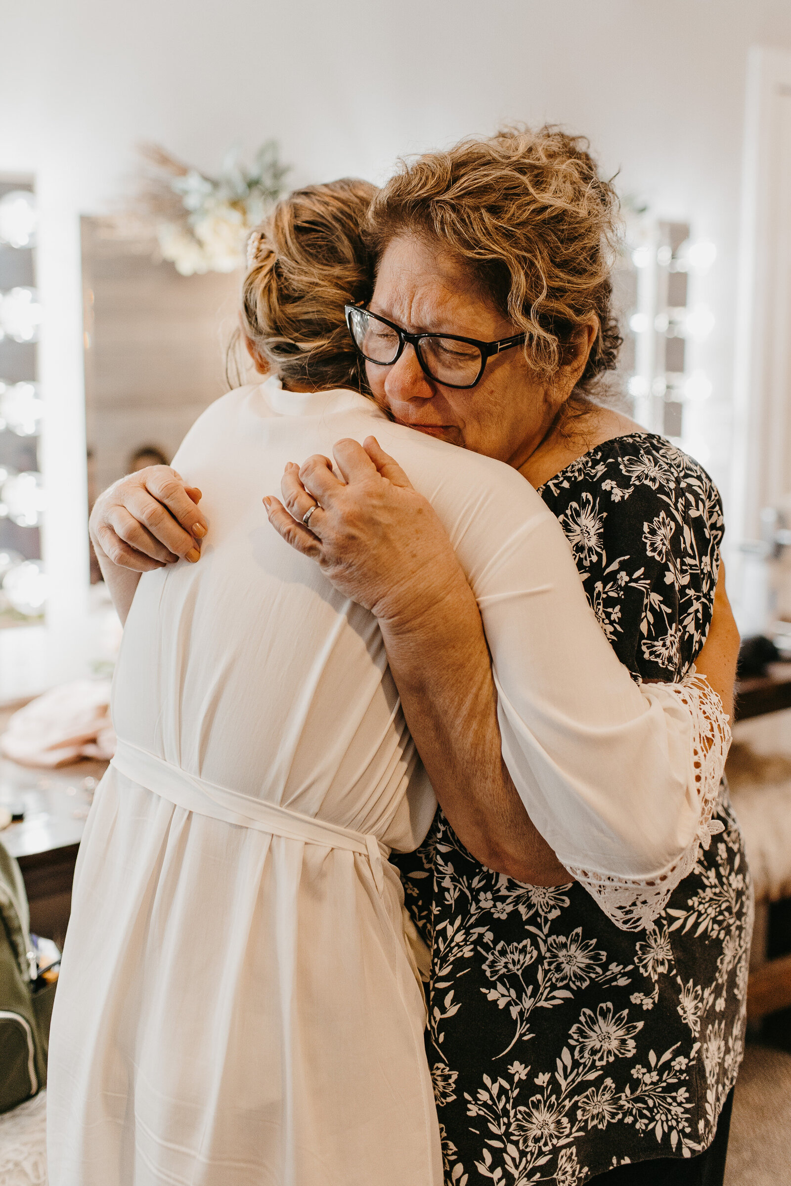 Mother and daughter embracing on wedding morning  - Alex Bo Photo