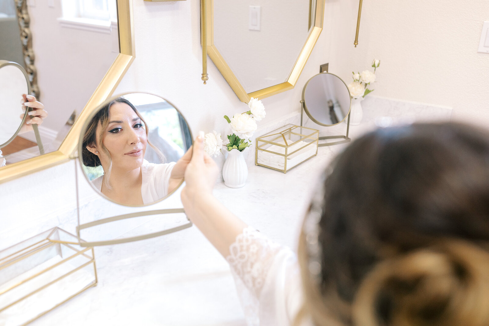 bridal portrait of bride in her bridal suite at Wolfe Heights with bride holding a mirror captured by sacramento wedding photographer