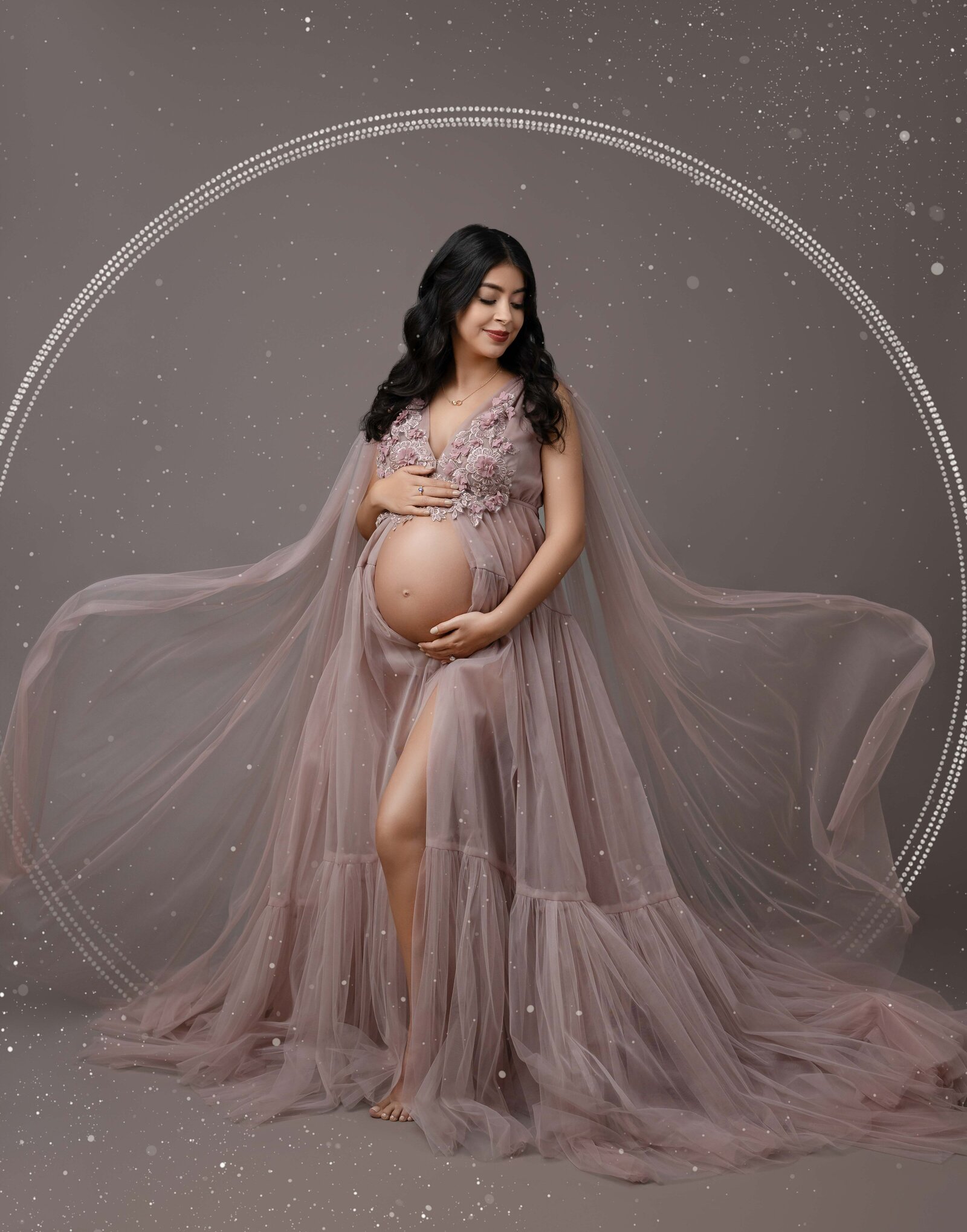 Mom wearing mauve maternity dress with fabric tossed in the air. Maternity portrait taken by Jenni. Nikki Photography at Atlanta Photo Studio. 