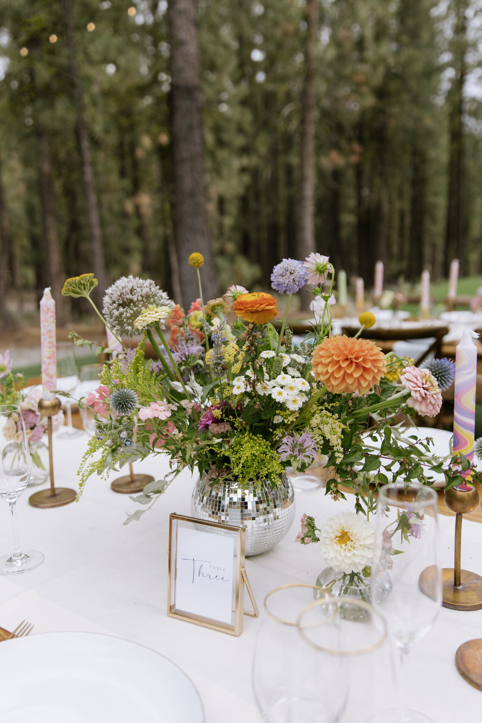 Close-up of eclectic retro tablescape at Tahoe wedding 