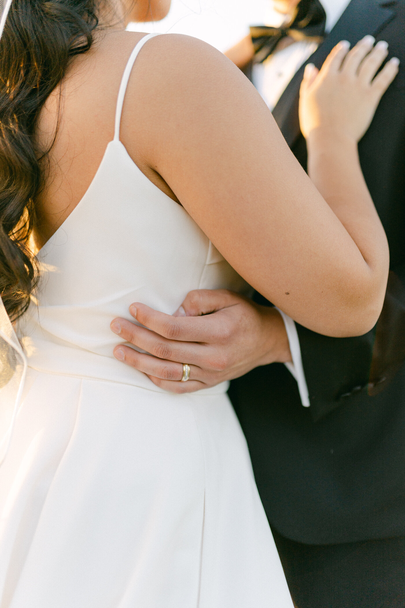 Texas Bride and Groom hold each other and show off the Groom's Wedding Band