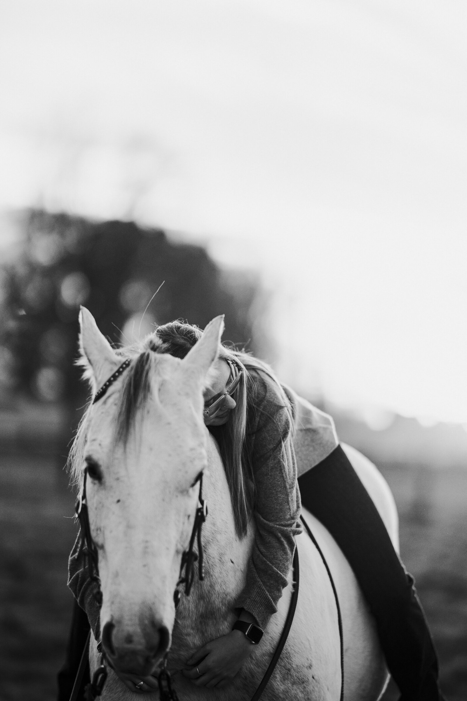 a girl riding her horse bareback hugging his neck