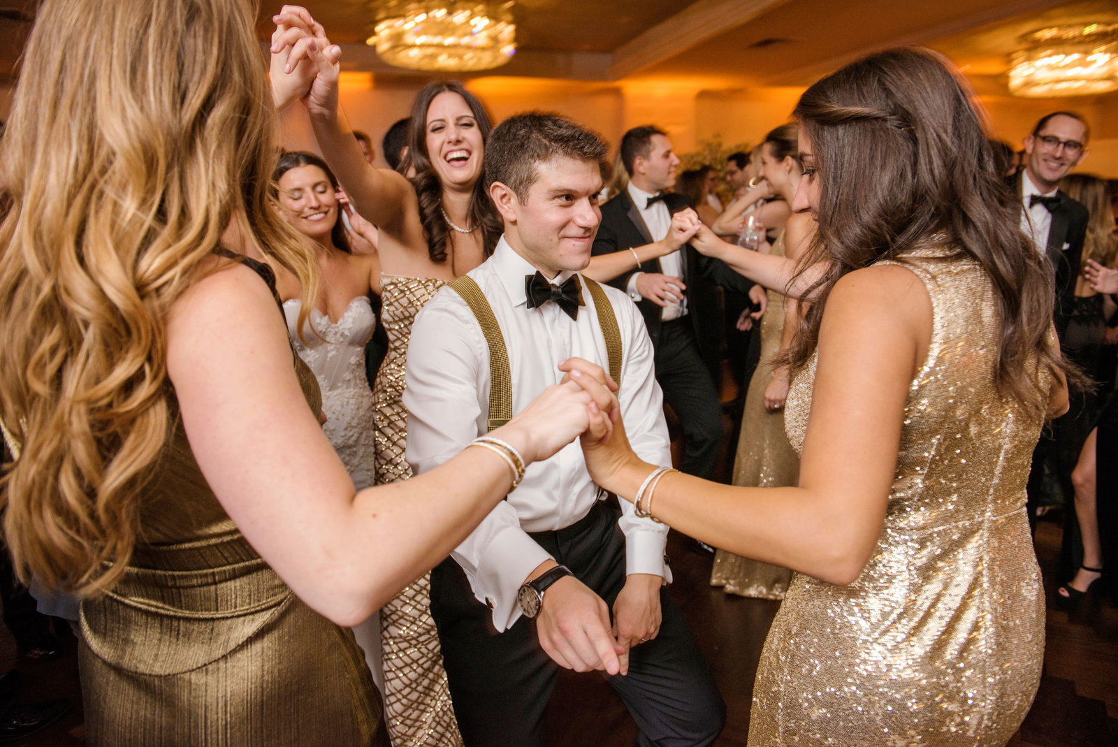 groom dancing with bridesmaids at Glen Head Country Club