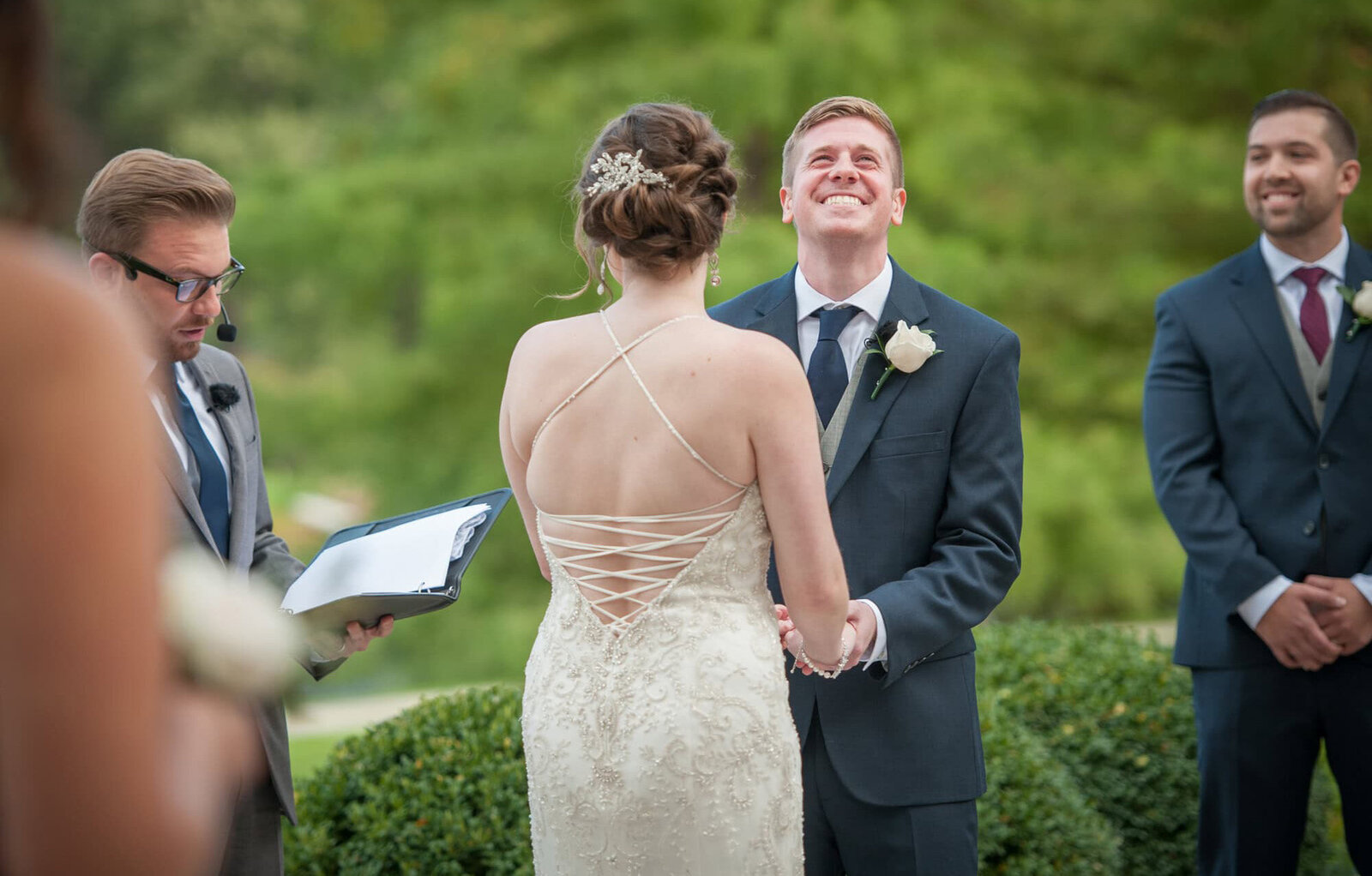 groom laughs during wedding ceremony