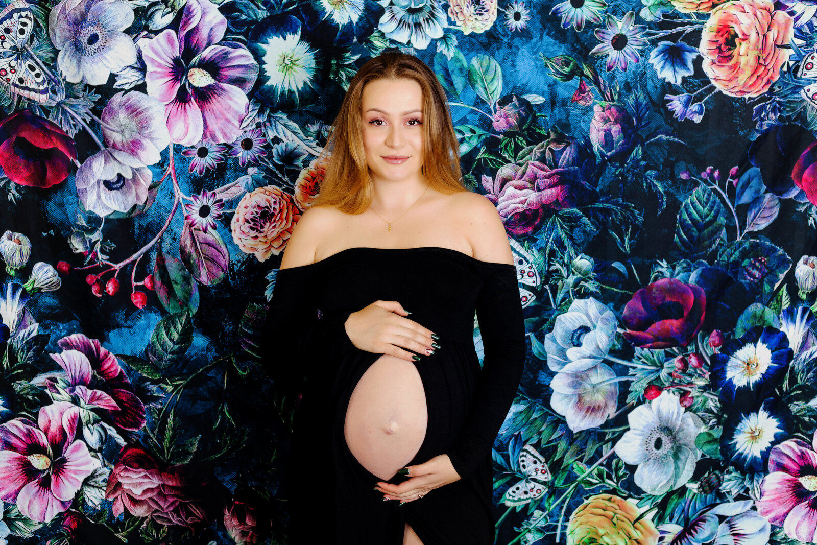 Maternity Photographer, a woman wears a dress that exposes her pregnant belly
