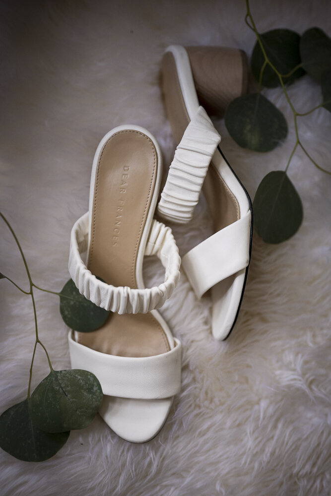 white wedding shoes on faux fur