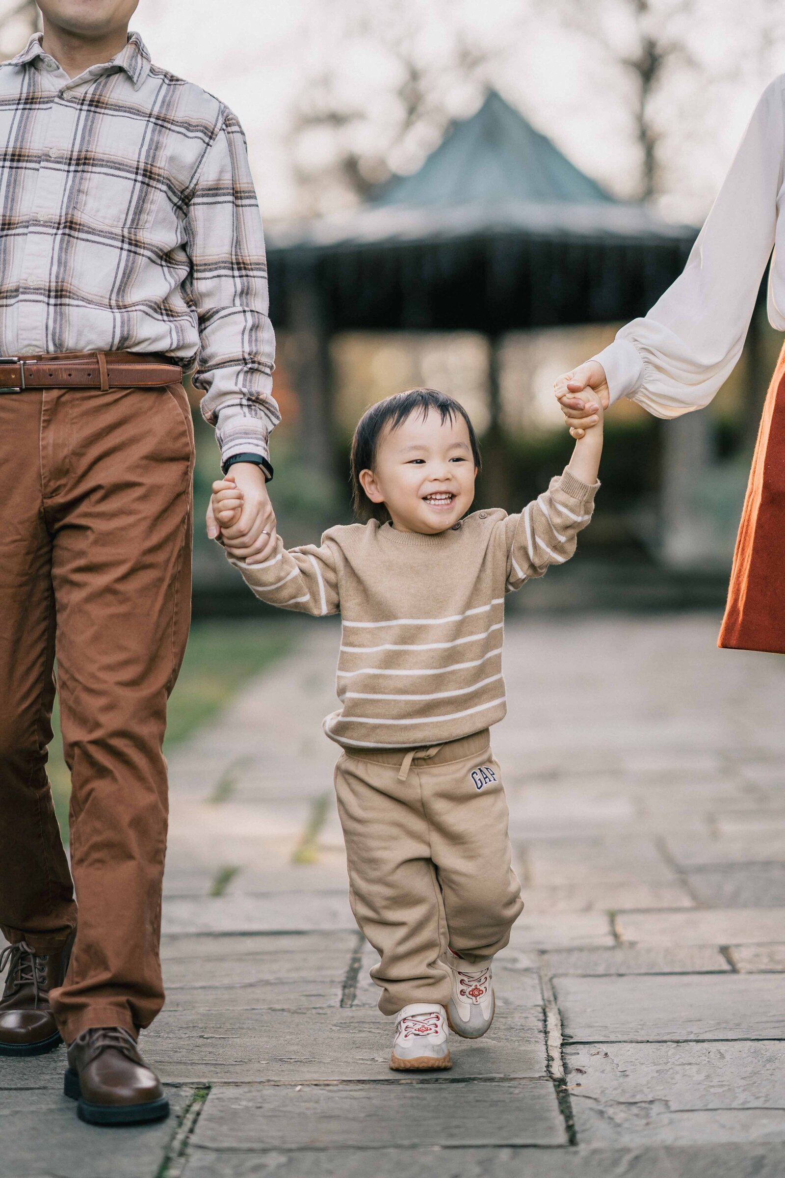 toddler laughing and walking by dc family photographer