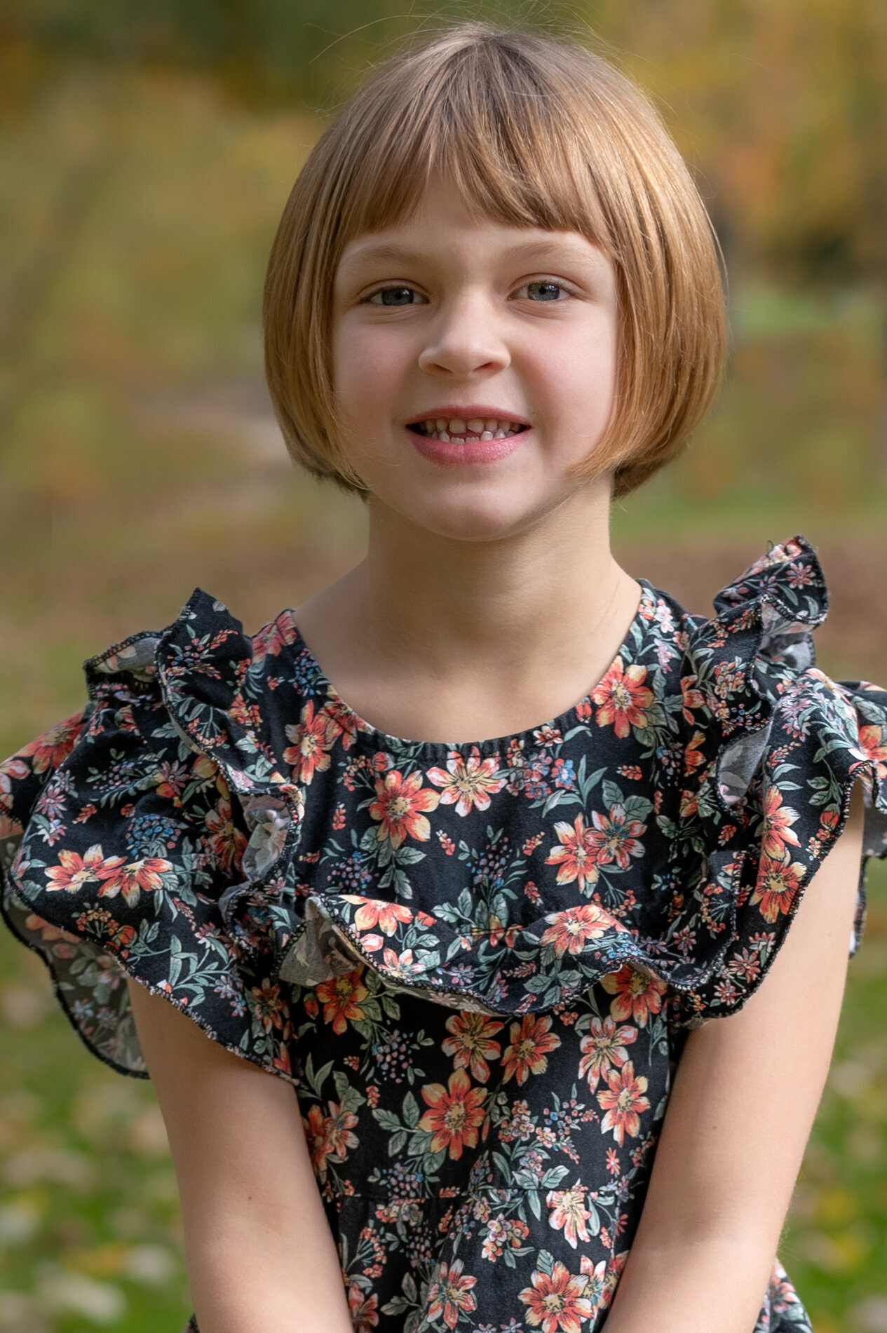 young girl sits outside for school picture
