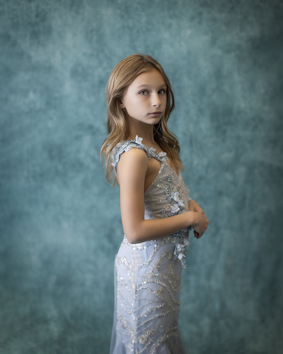 Girl stand in blue beaded dress