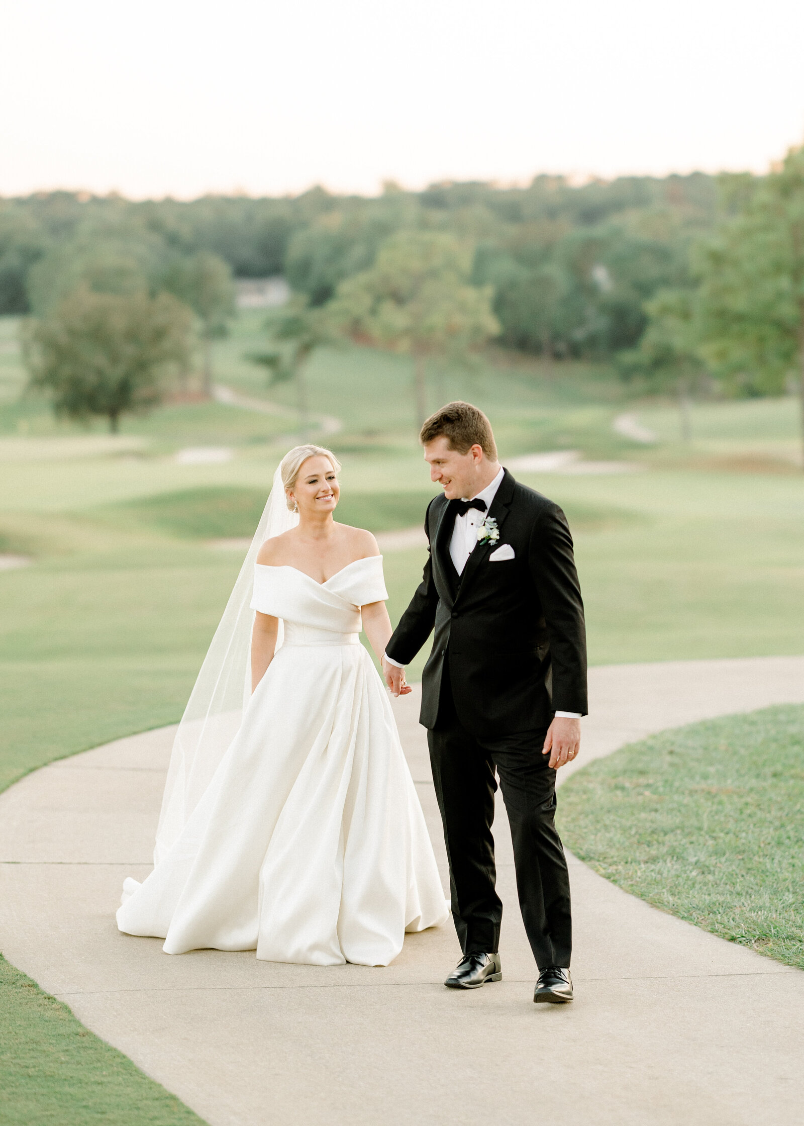 Mallory and Jack riding in a vintage car, a perfect representation of romantic wedding photography in Alabama.