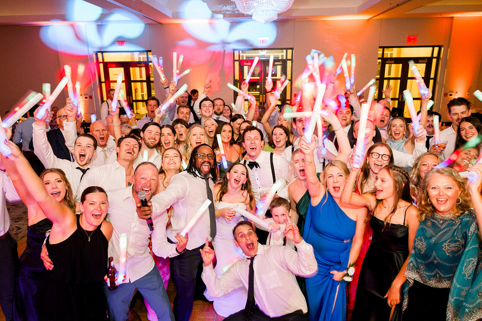 High-energy wedding reception with packed dance floor and Chicago DJ light show
