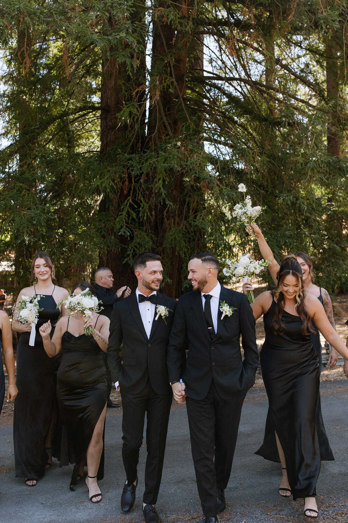 Bridal party celebrating with two grooms in Ukiah vineyard wedding