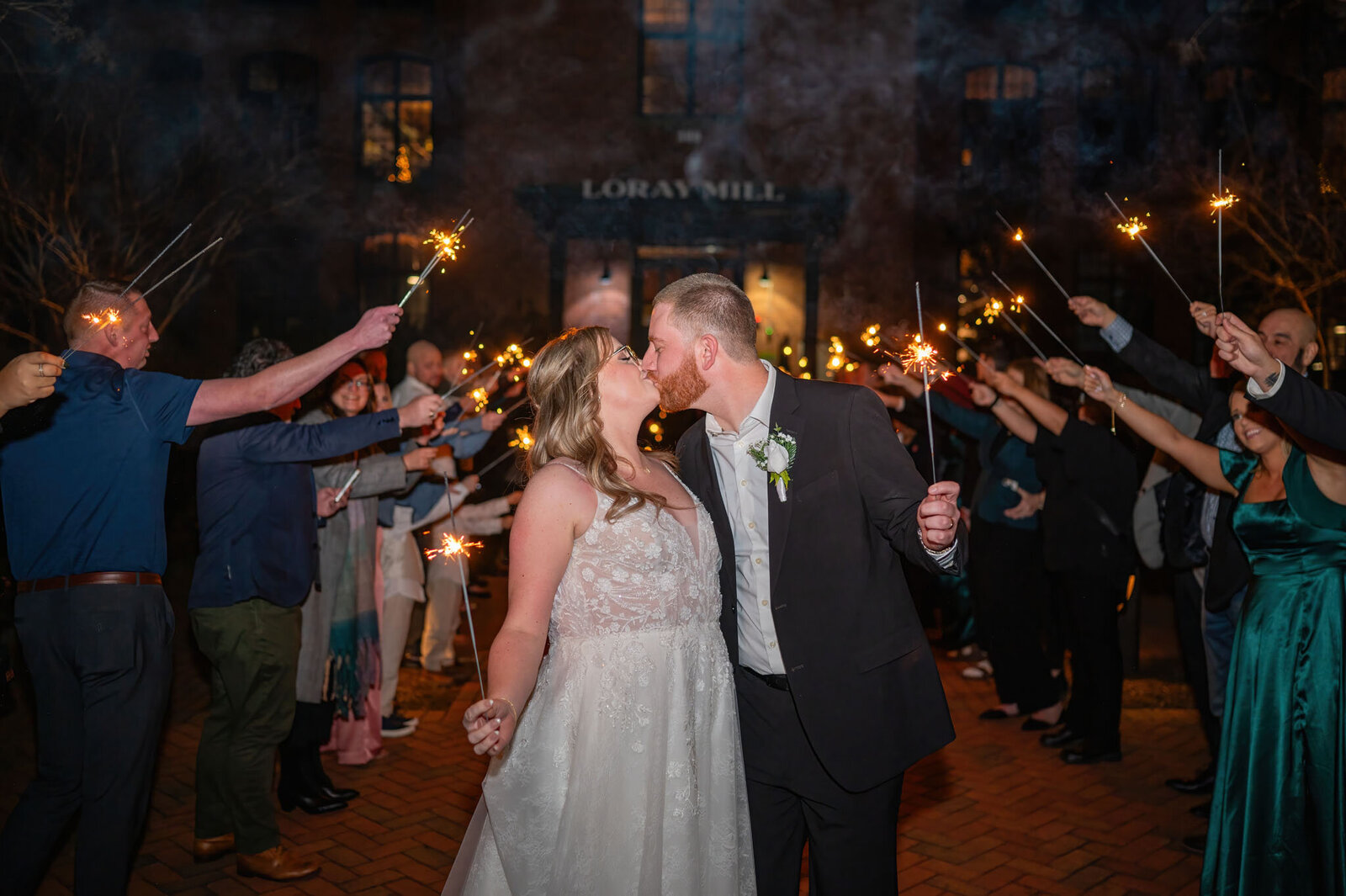 Bride and groom wedding exit with the guests holding sparklers