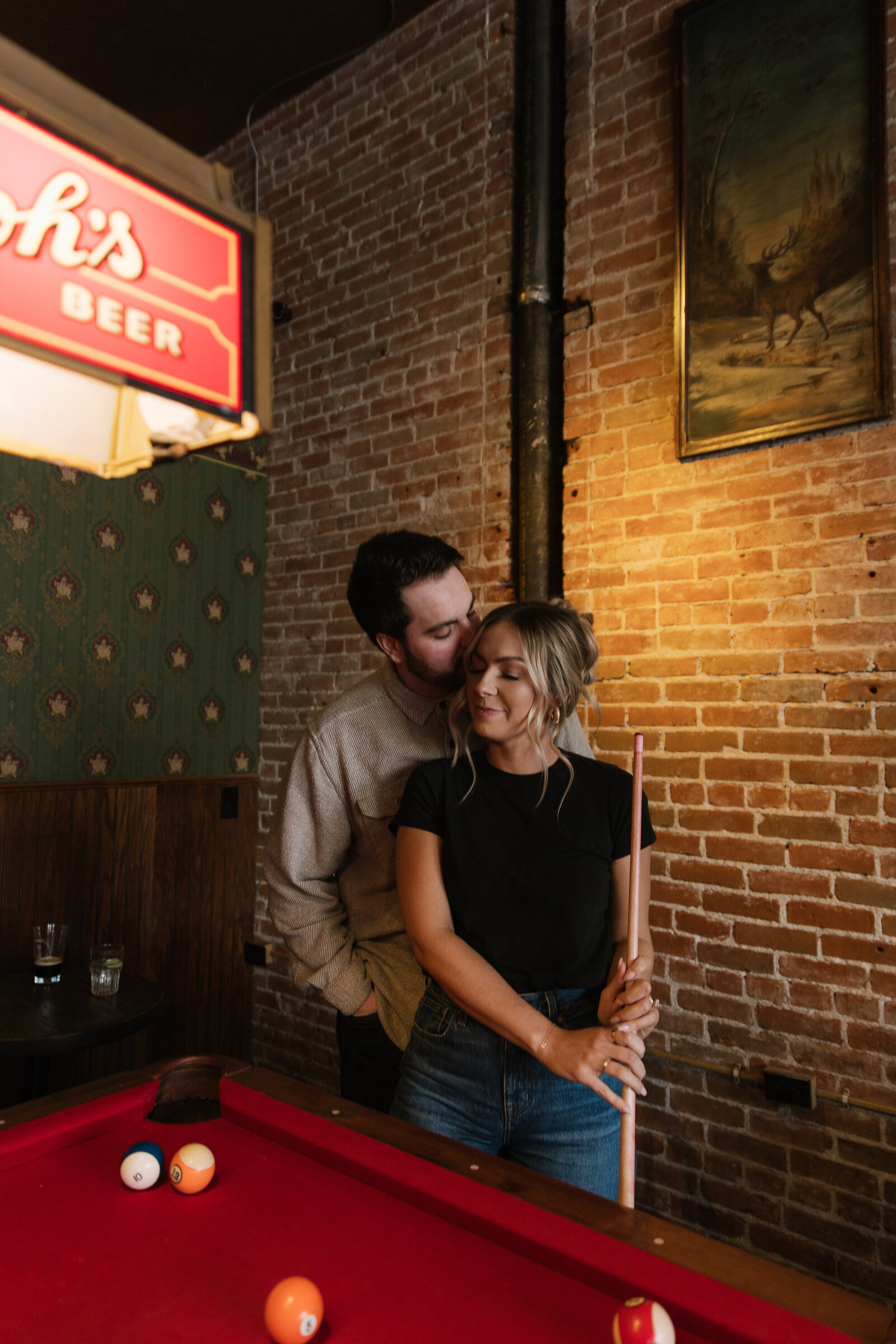 Boise couple enjoying flirty saloon engagement session