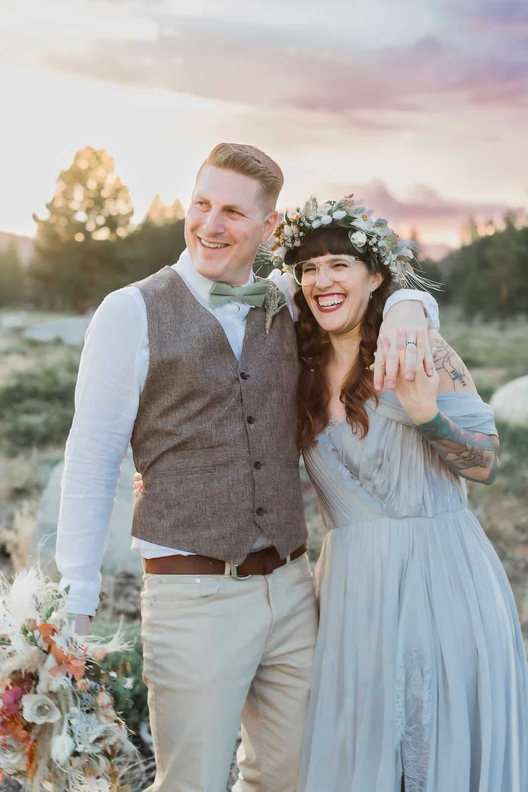 A bride and groom laugh together during sunset on their mammoth lakes wedding day. 
