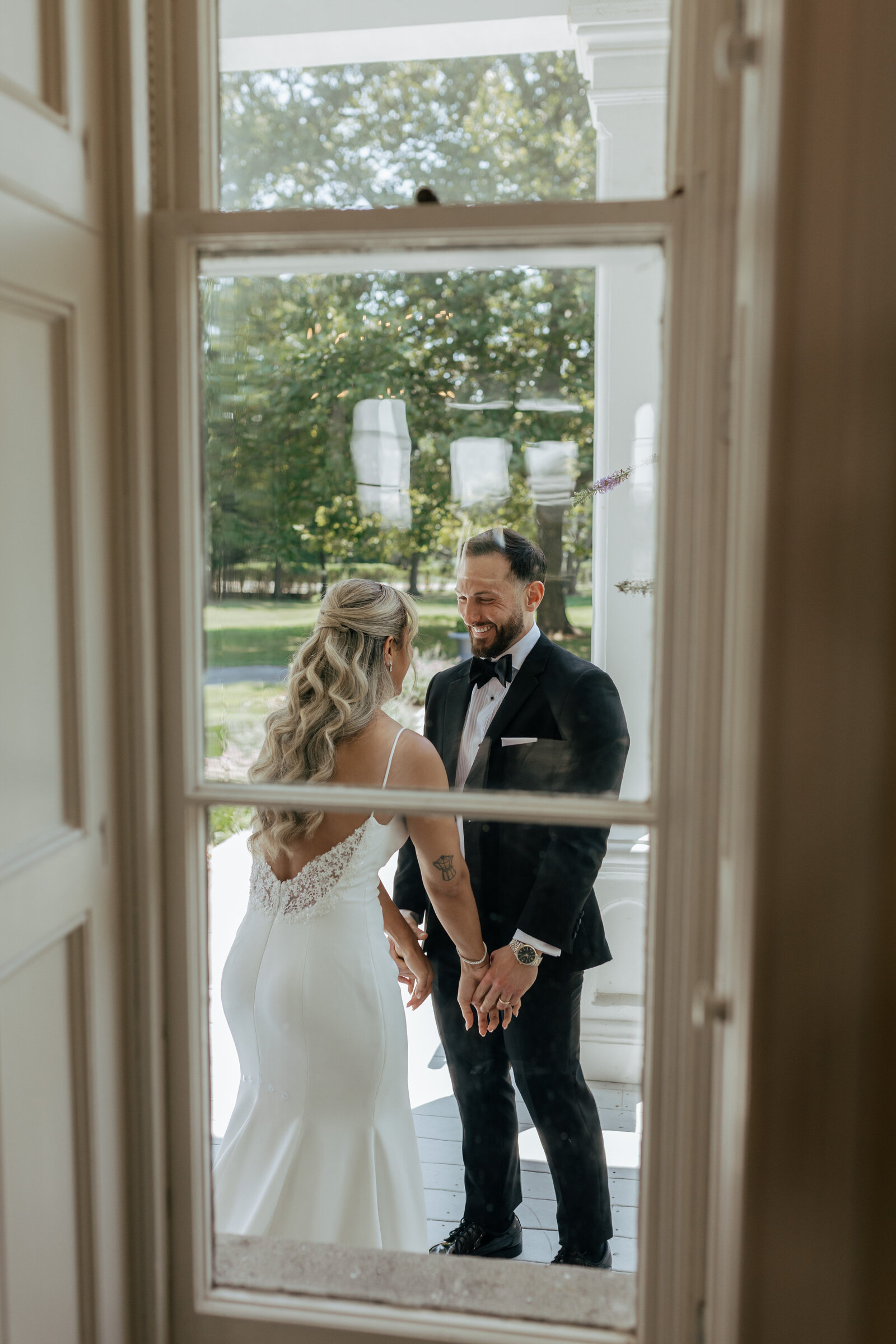 Through the window POV of bride and groom holding hands after their wedding ceremony | Emma LeeAnn Photography