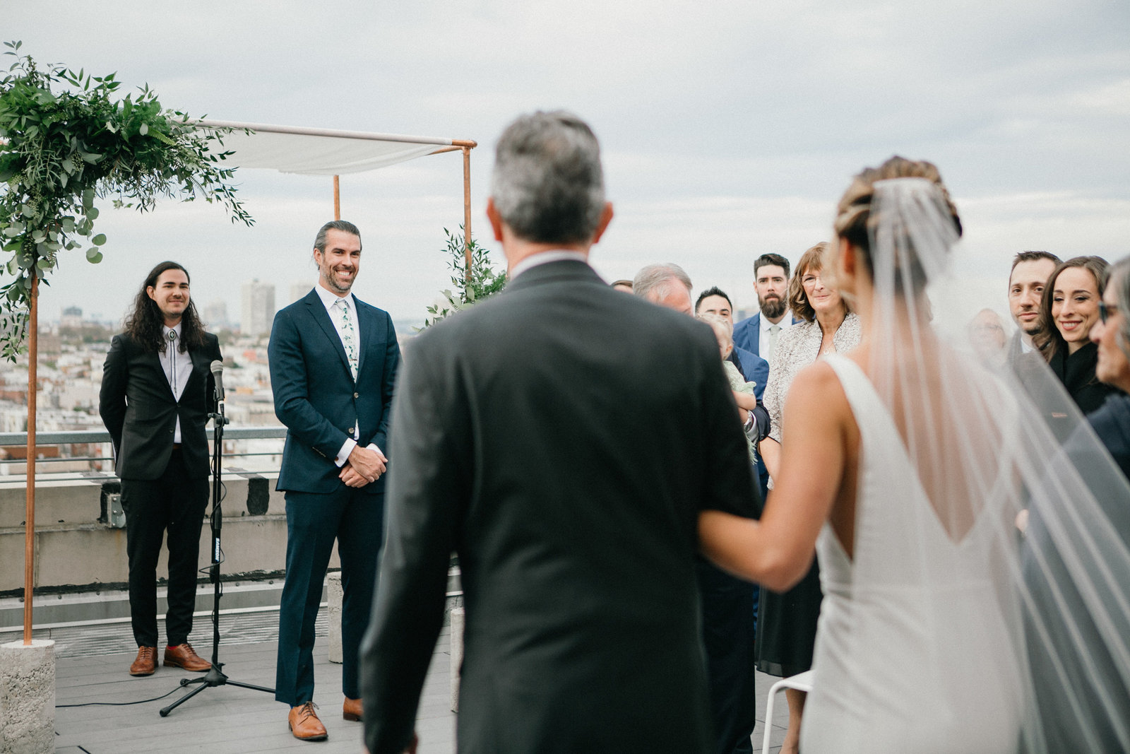 Bride walking down the aisle at this rooftop wedding ceremony in Philadelphia.