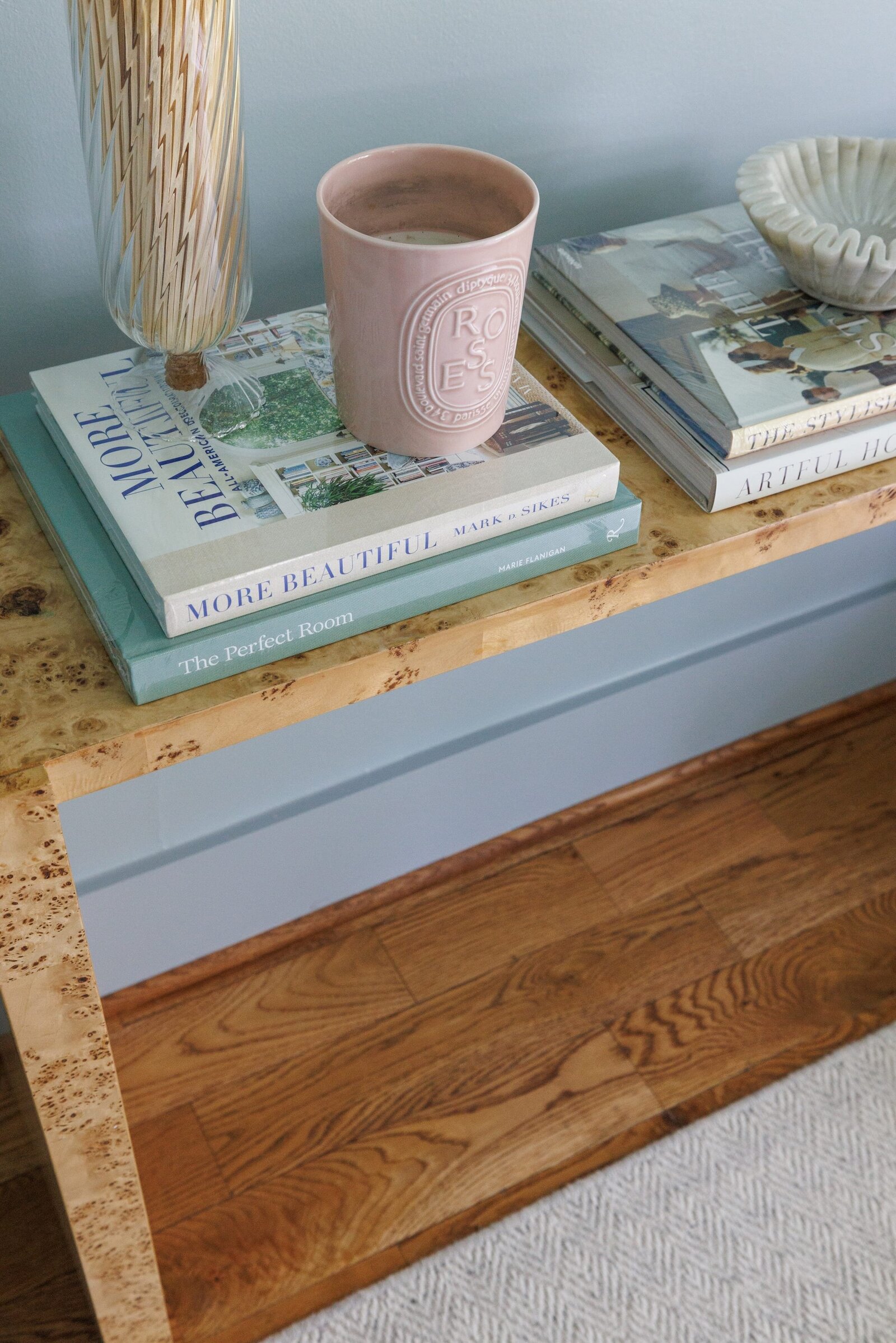 vision and hammer styled table with book and pink candle