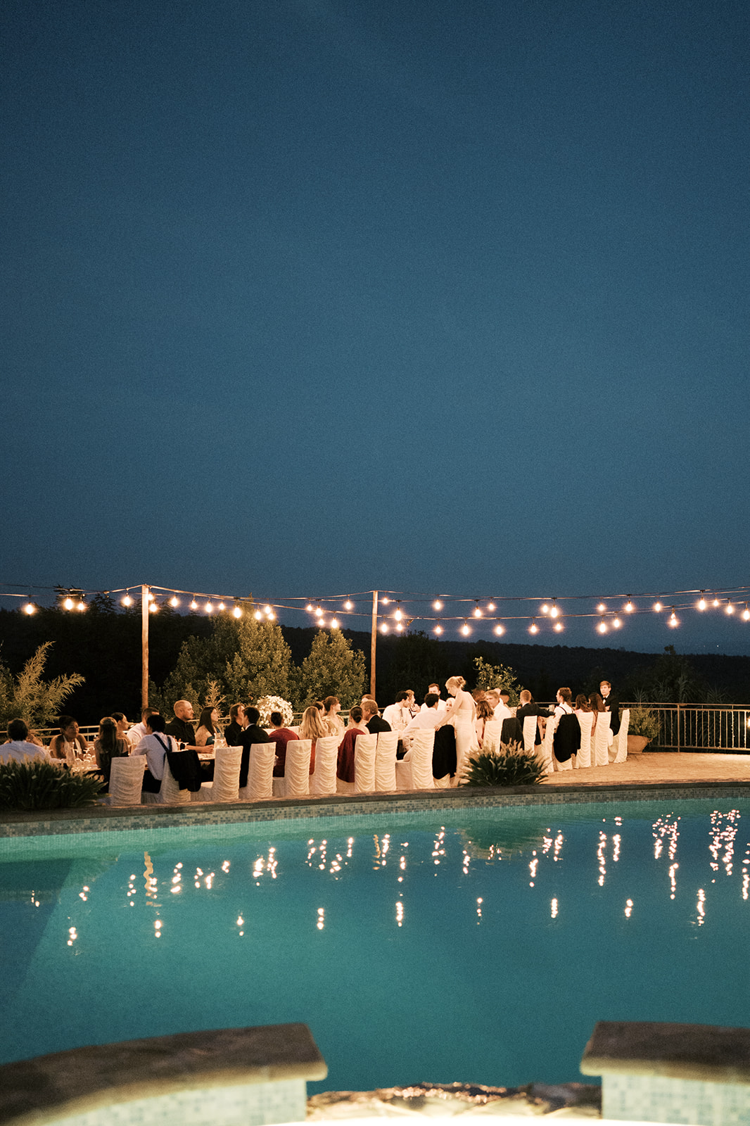 Small wedding dining by the poolside at wedding | Megan Smith Photography