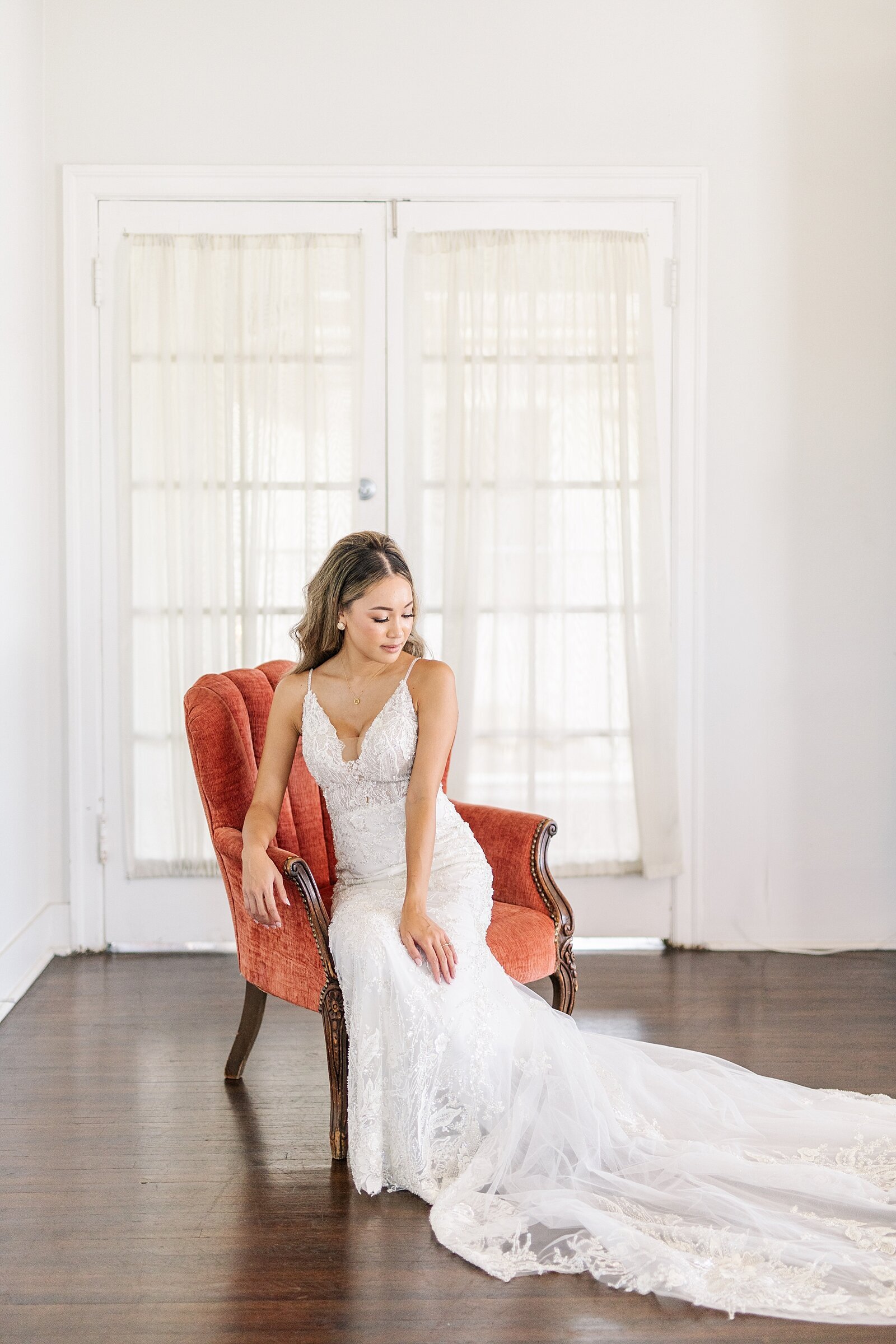 Bride sitting on chair in bridal suite at Monserate Winery in Temecula, California.