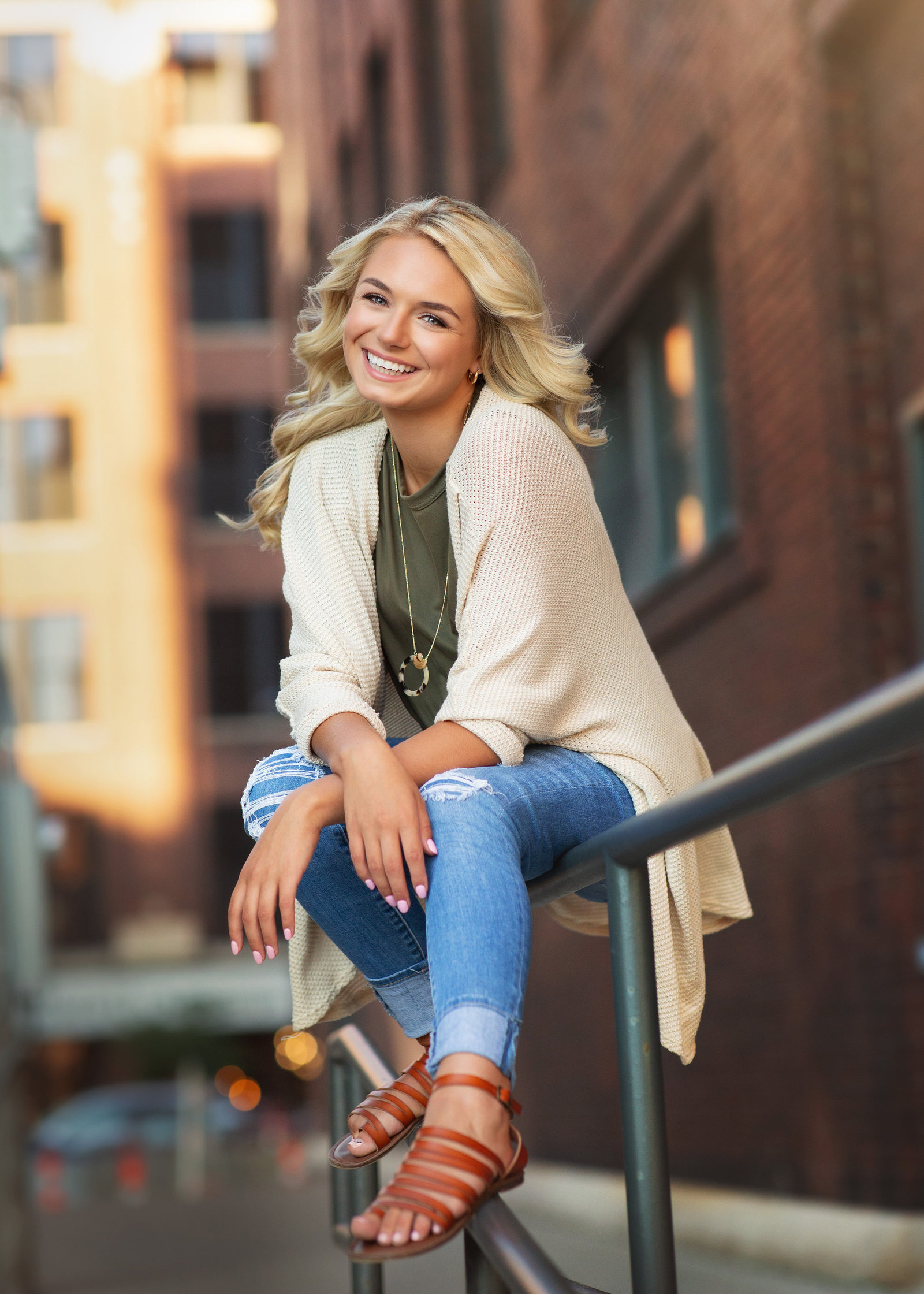 Senior girl sitting on railing