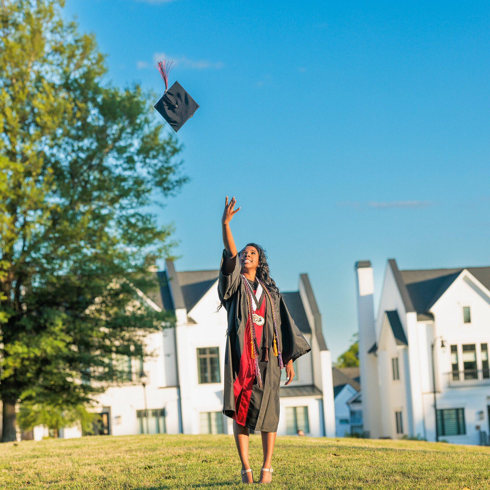 girl tossing cap