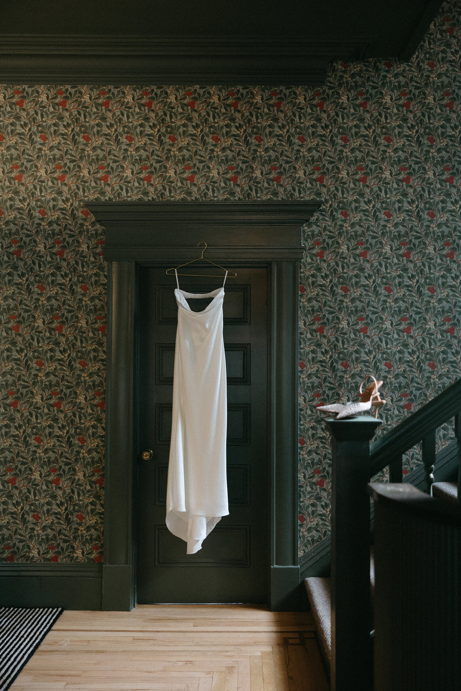 A wedding dress hangs on a doorframe of an airbnb in Newfoundland. 