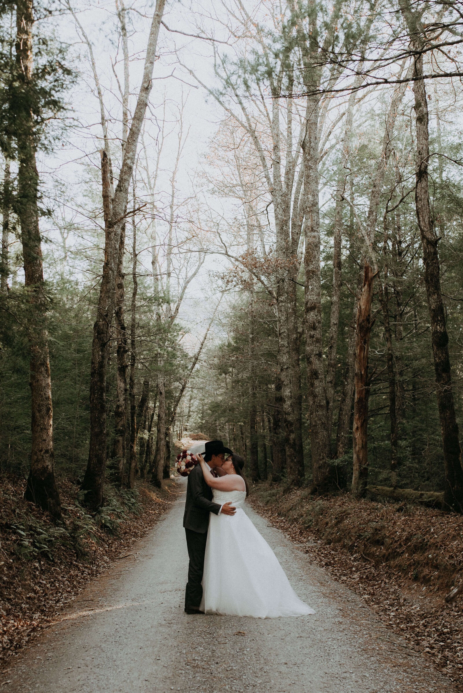 bride and groom portraits on dirt road