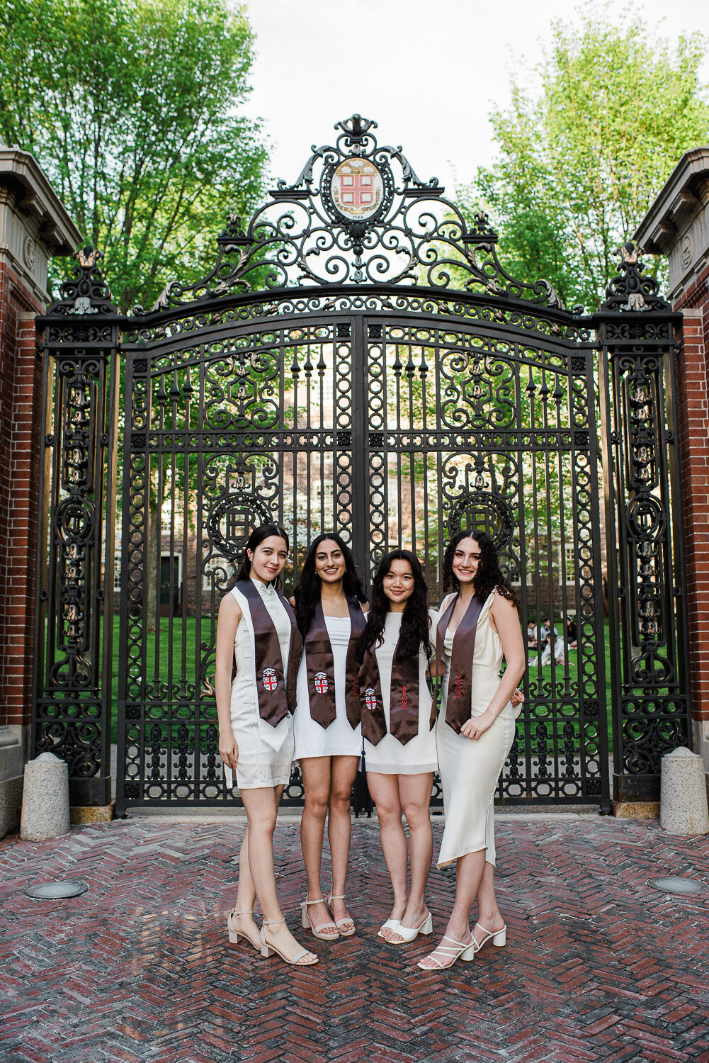grad girls with sashes in front of school gate