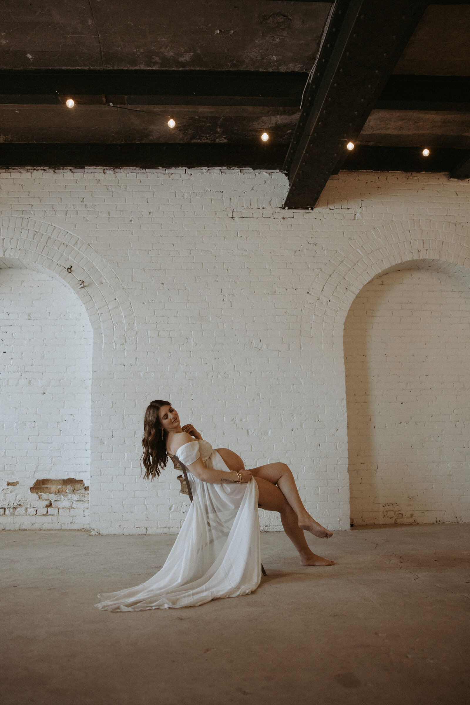  maternity photos of woman sitting in a chair in a montana studio