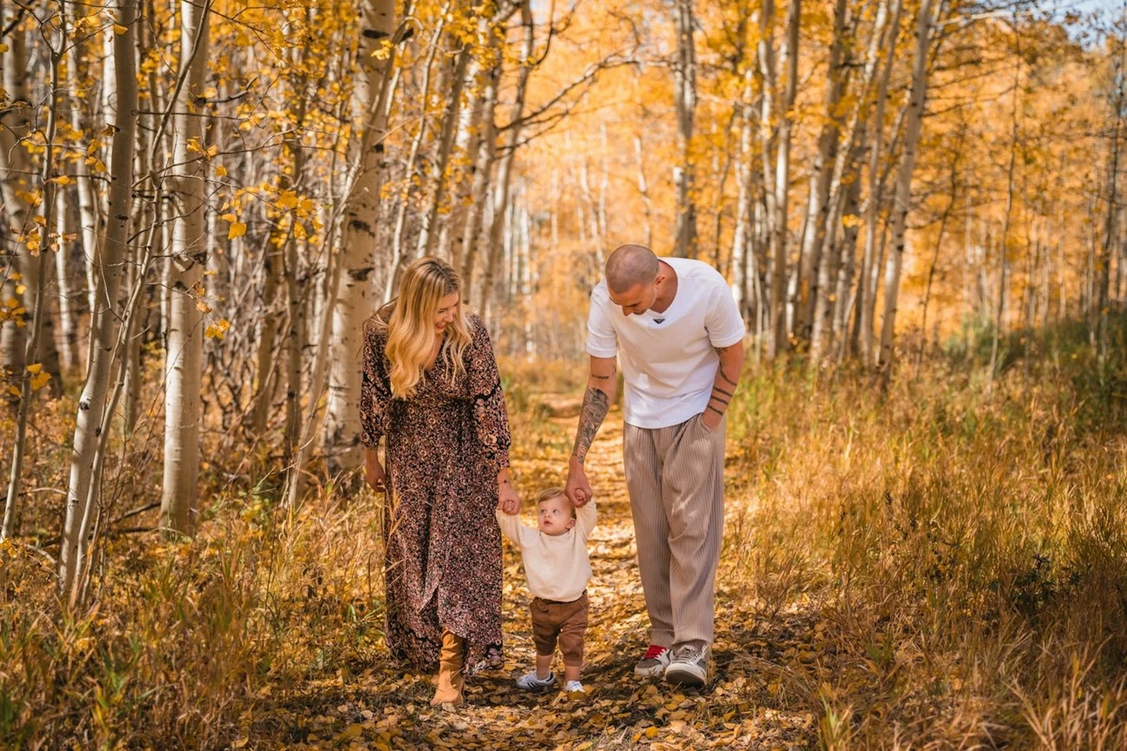 Family together among golden Aspen trees