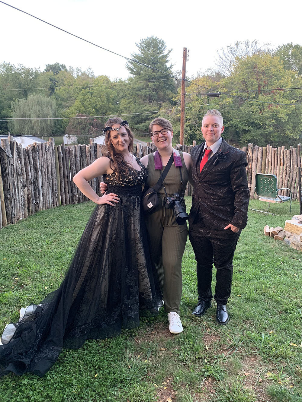 A Virginia wedding photographer stands with a queer couple on their wedding day in Roanoke, Virginia at an Airbnb that they rented for the day.