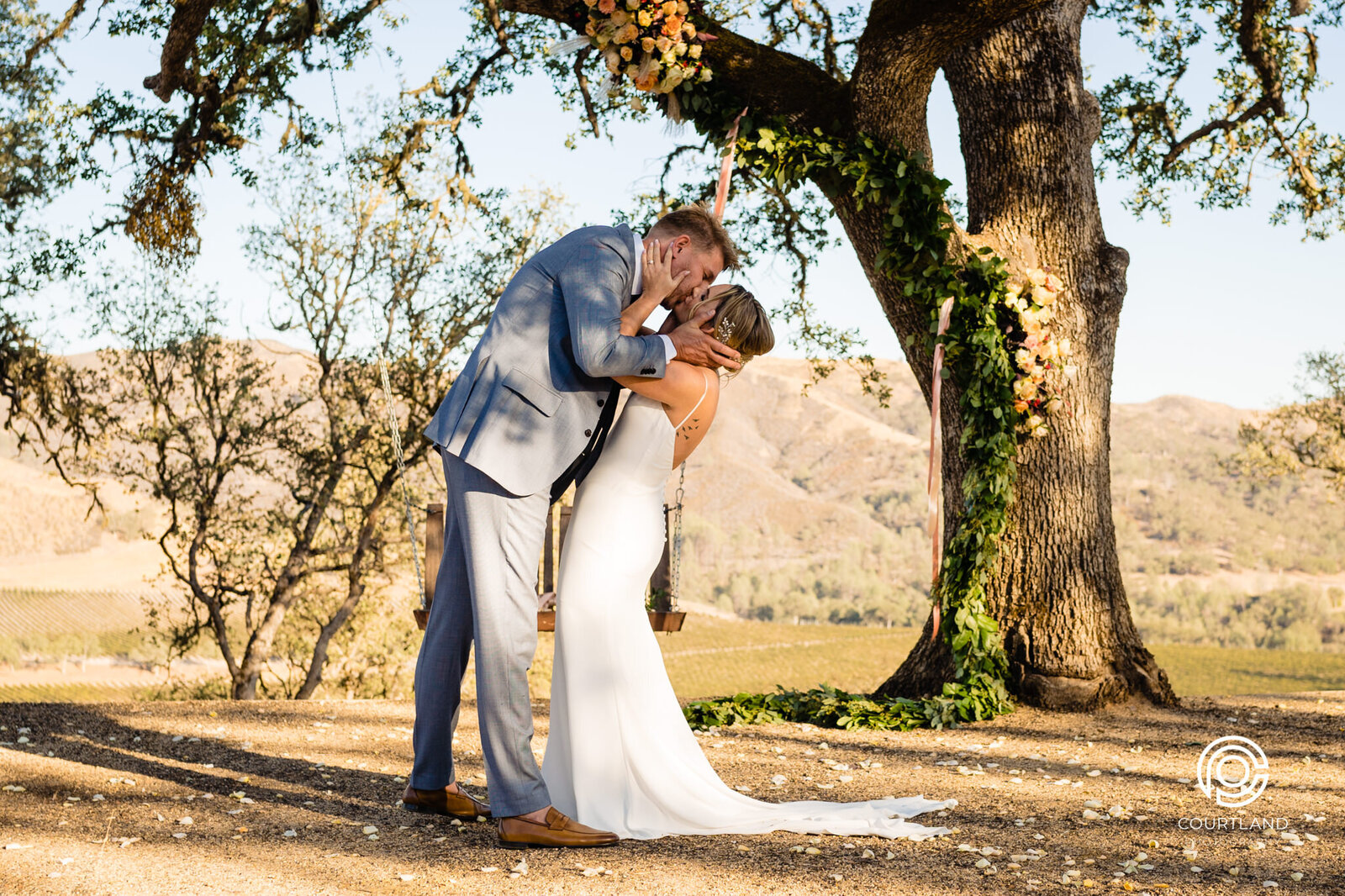 Couple kissing hi above a vineyard in clearlake  califronia