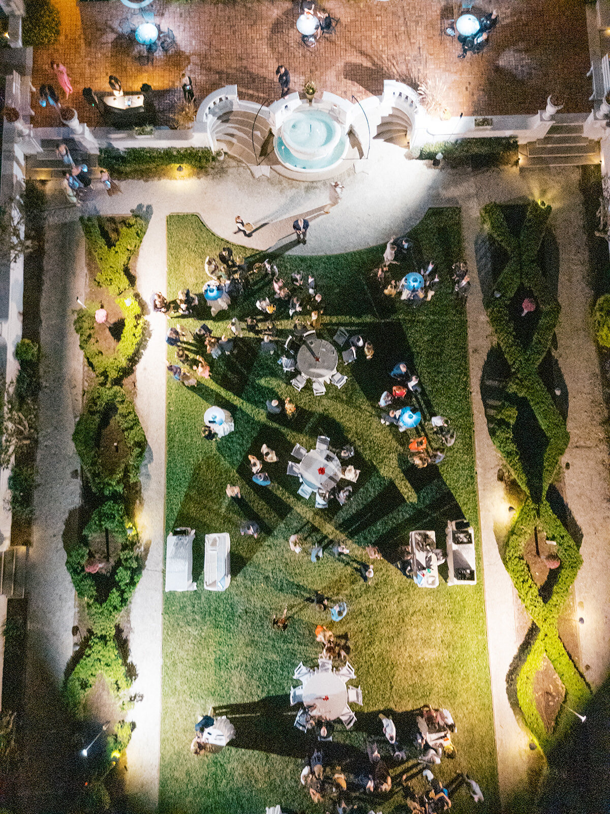 Glowing Aerial drone photo of post toast event in Crane Cottage's courtyard