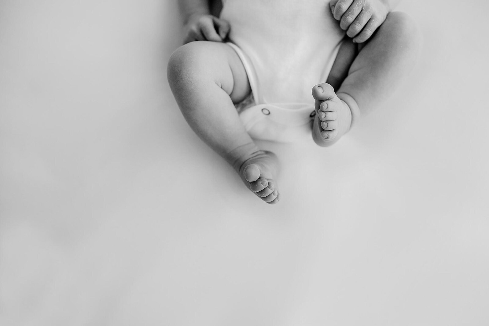 simple and natural black and white photo of baby legs