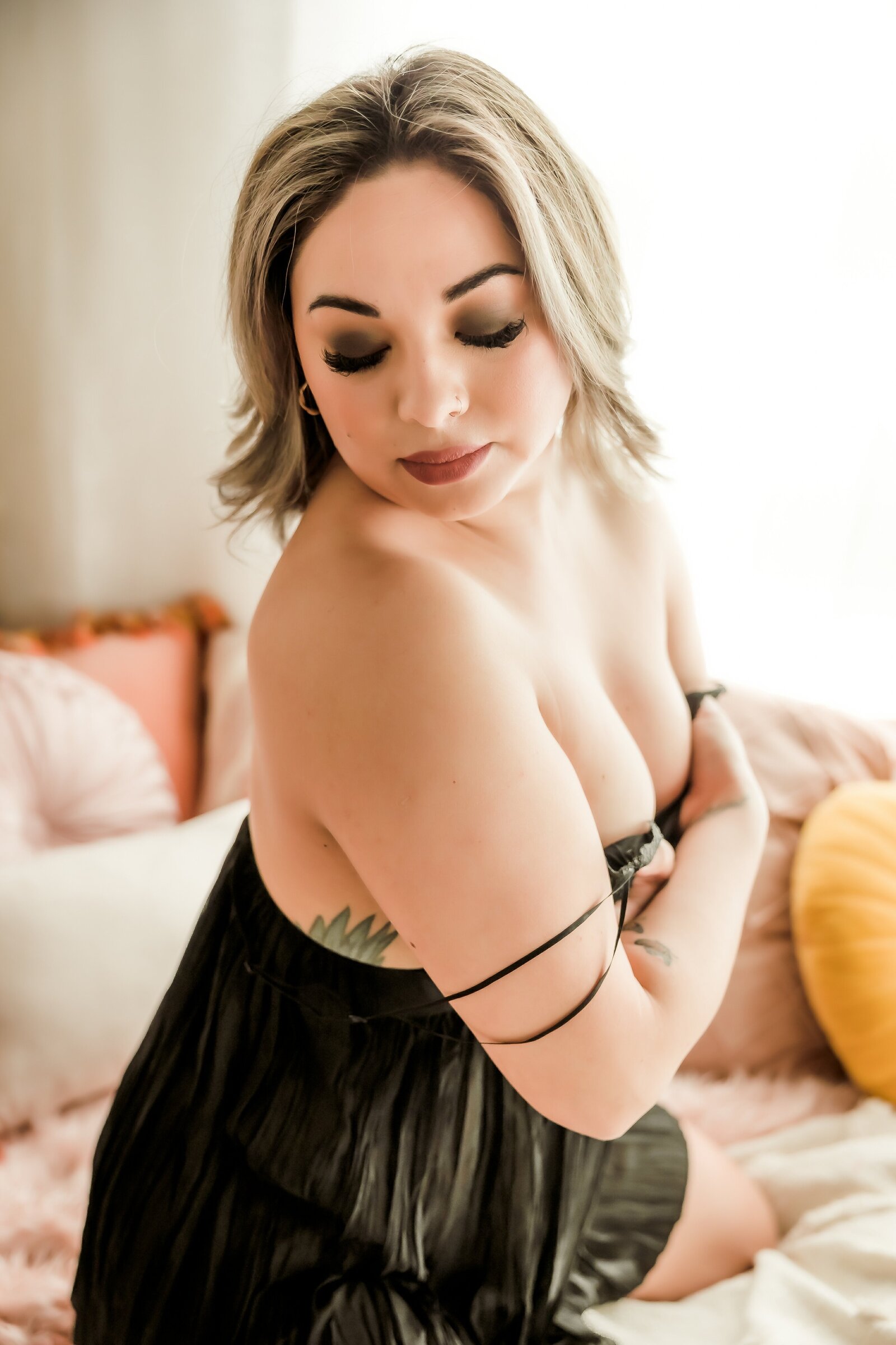 Portrait looking down to her right wearing black lingerie