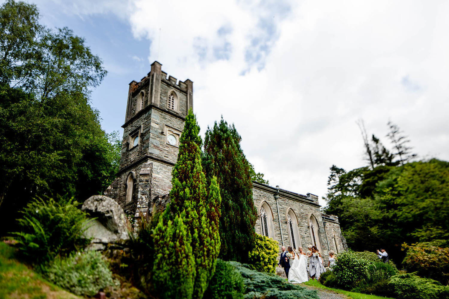 bride arrives at church ready for her wedding with bridesmaids