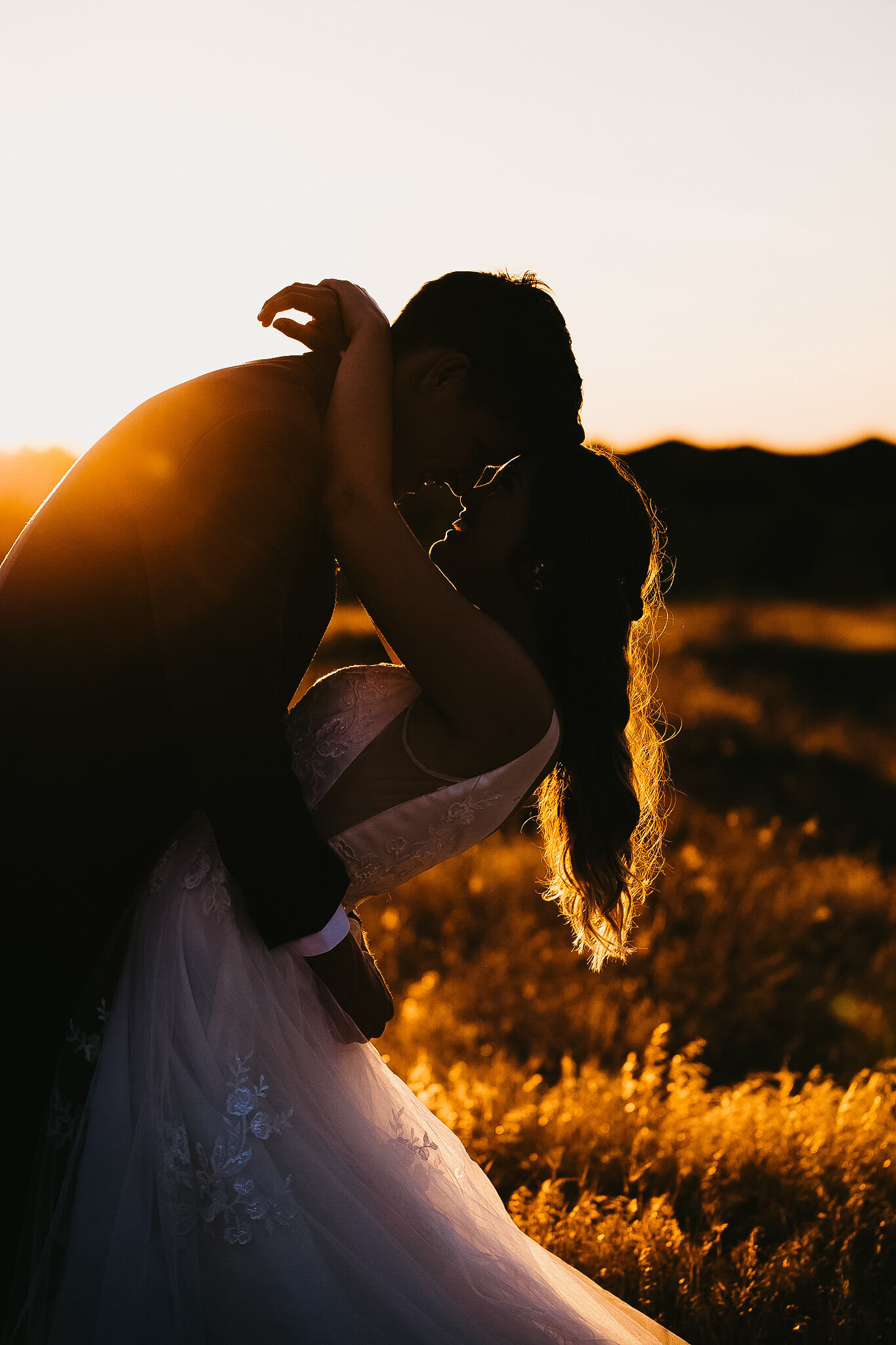 Bride and Groom hugging in the sunset