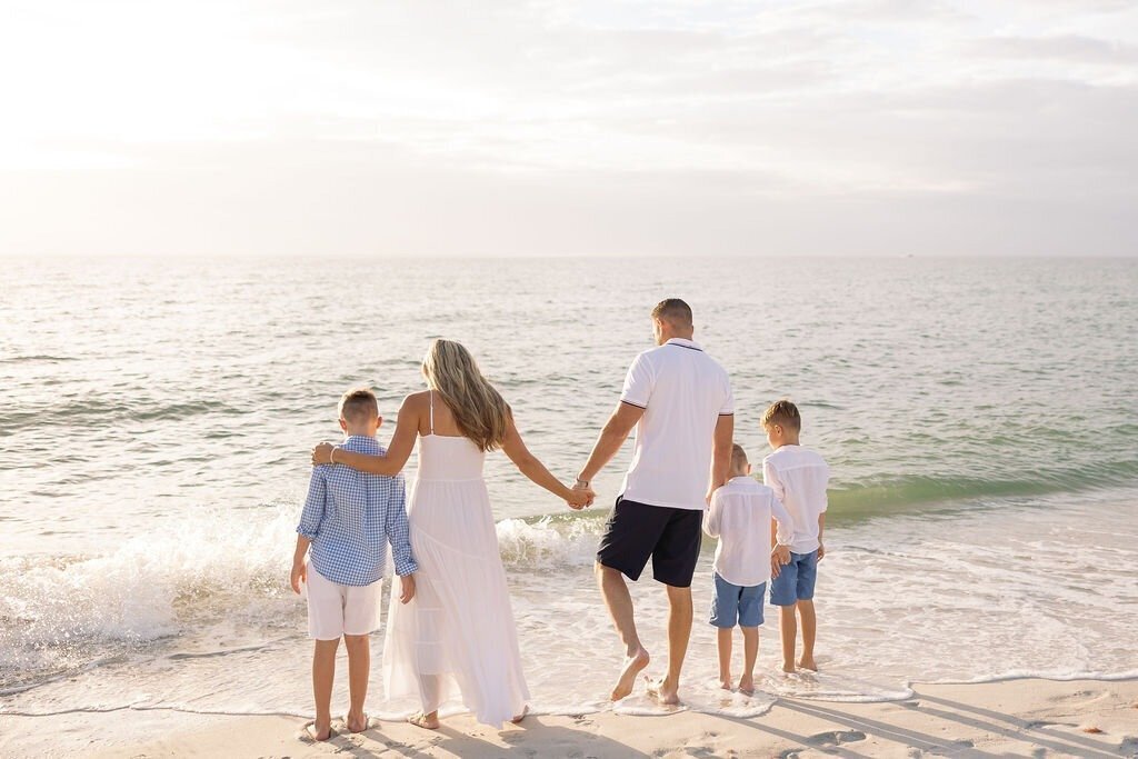 family playing in Naples beach