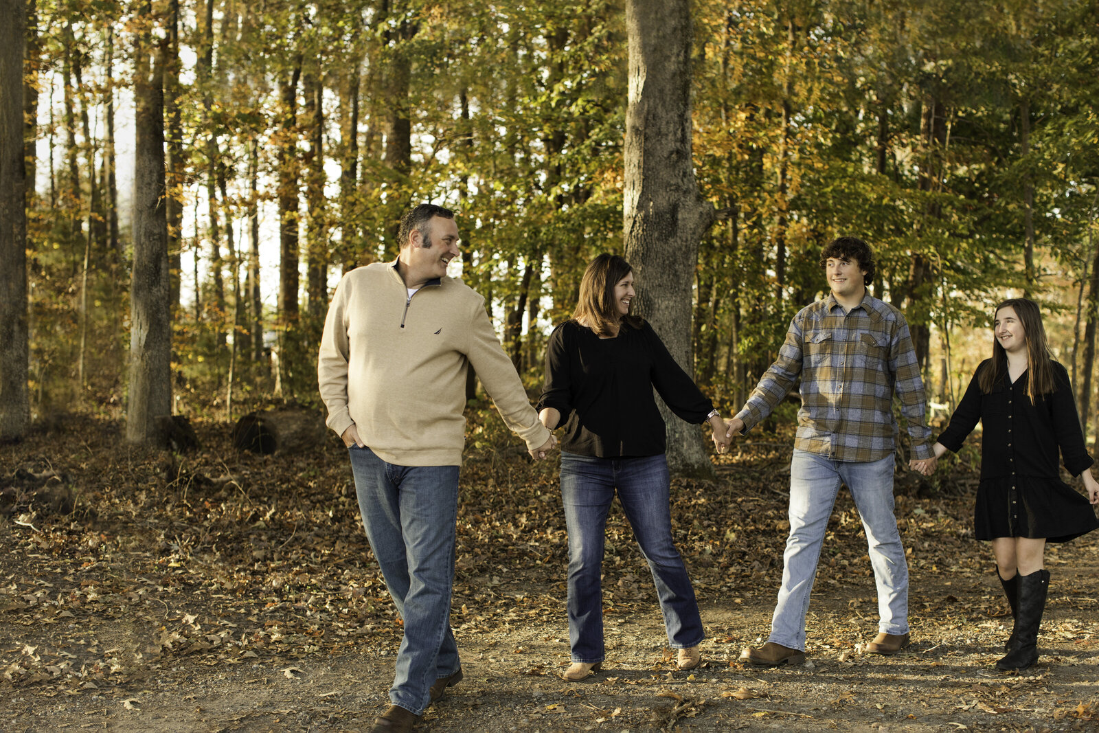 family of four walking down a dirt road