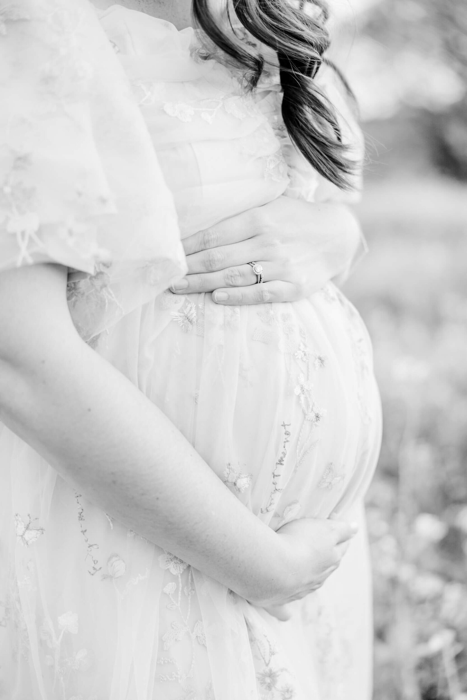 Black and white closeup of a mama's baby bump