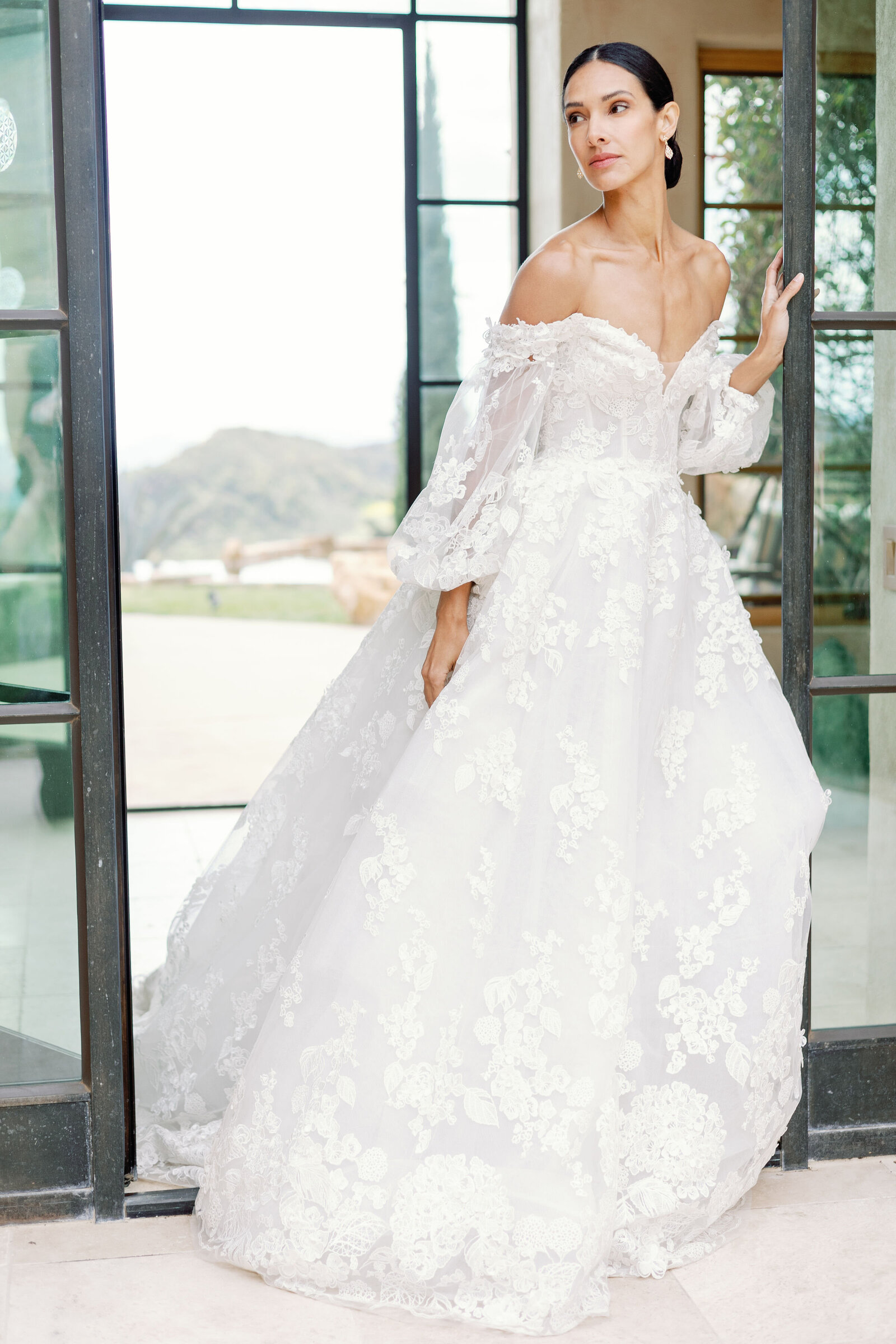 outdoor bridal portrait captured by wedding photographer bay area with the bride walking out of the bridal suite door as her bridal gown trails behind her captured by wedding photographer bay area